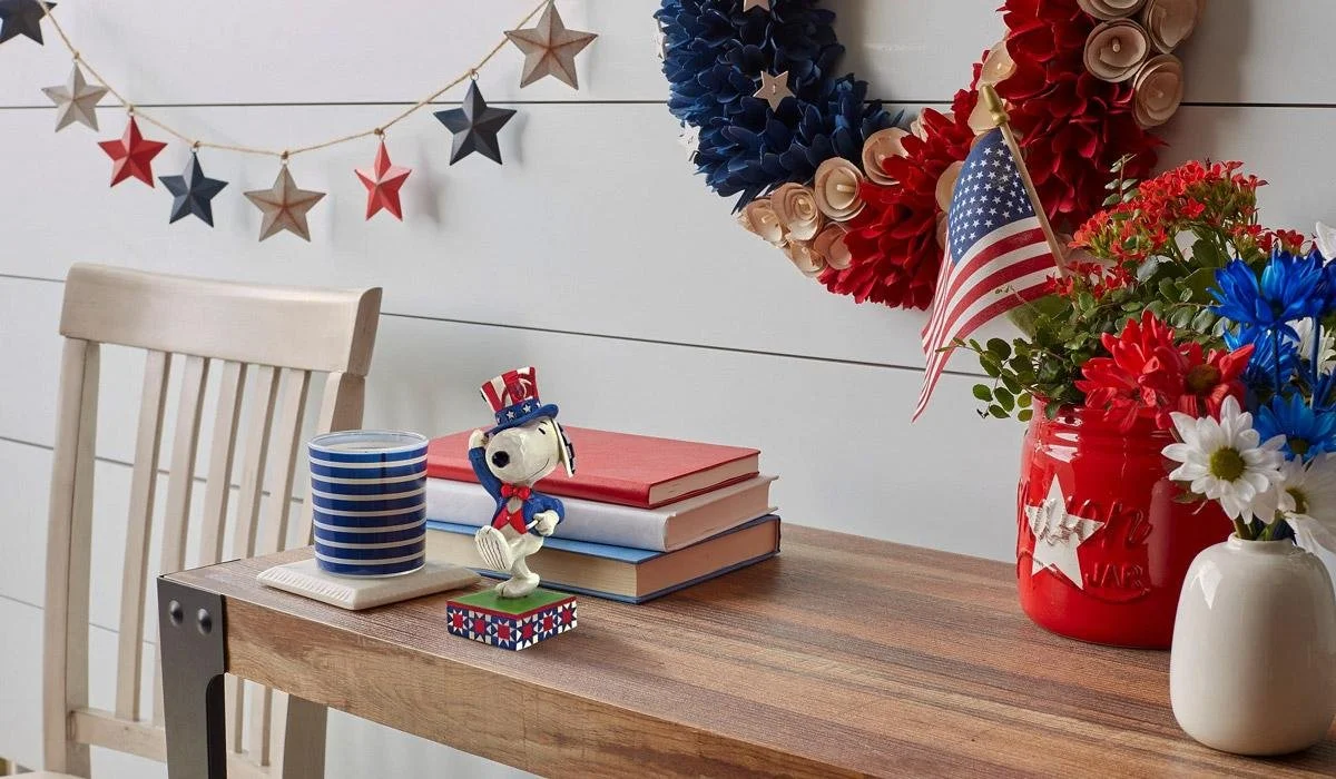 patriotic Snoopy figurine on a desk with American flags