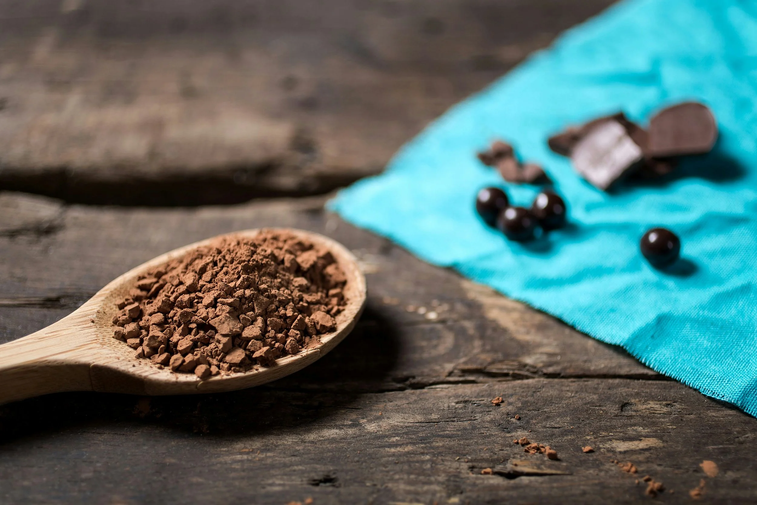 A scoop of protein powder beside supplement capsules