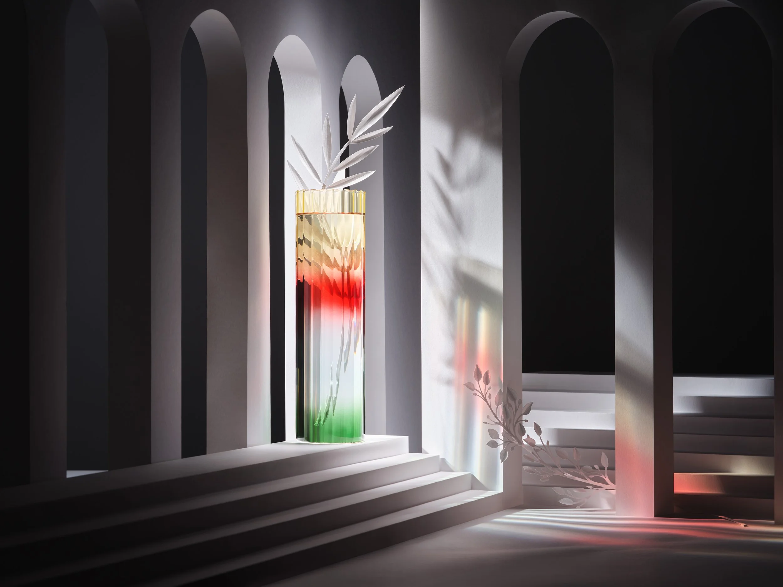 Paperart setdesign of white paper architecture and intricate paperflowers with a colourful red vase