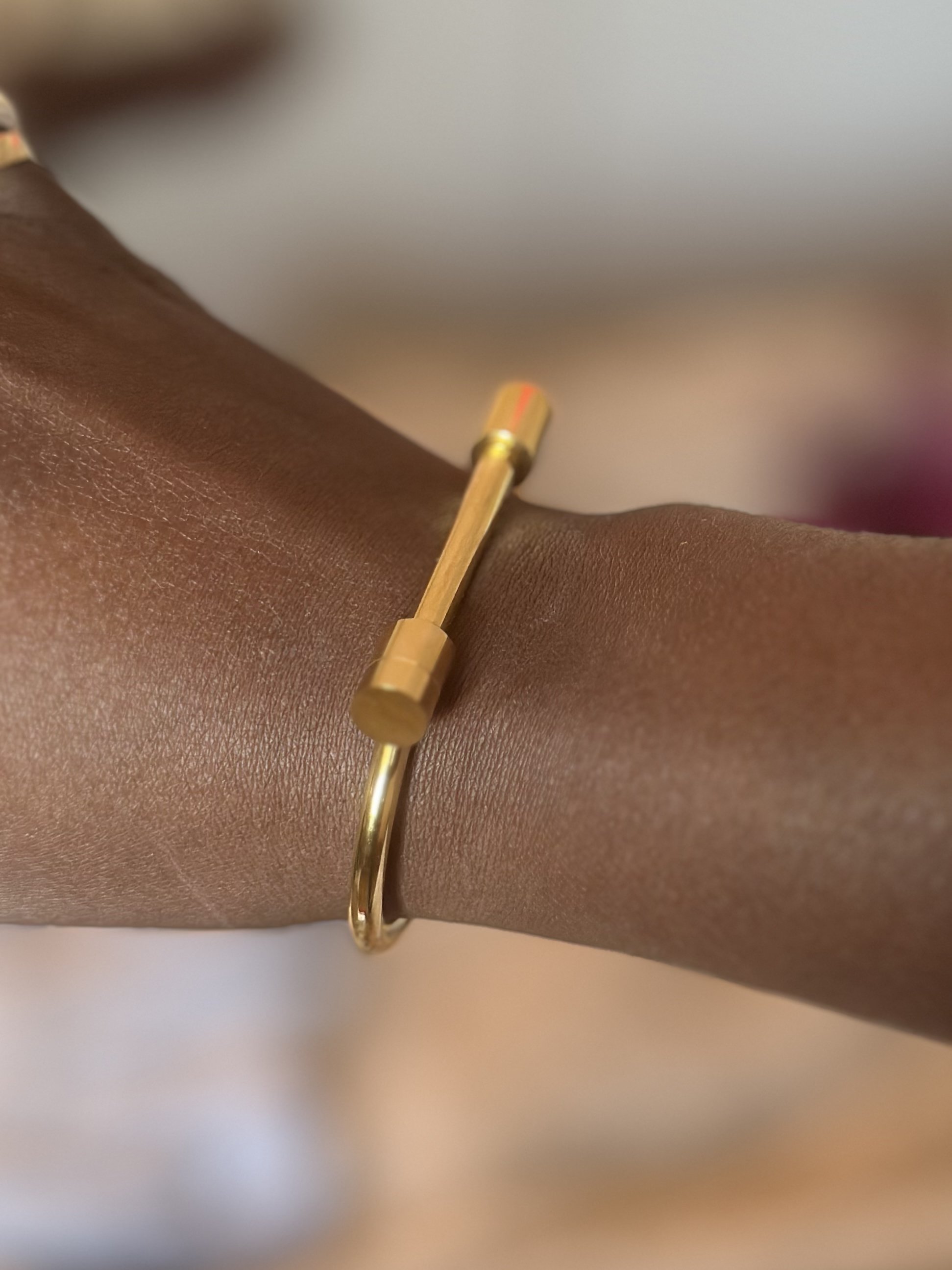 Minimalist goddess bangle styled on wrist