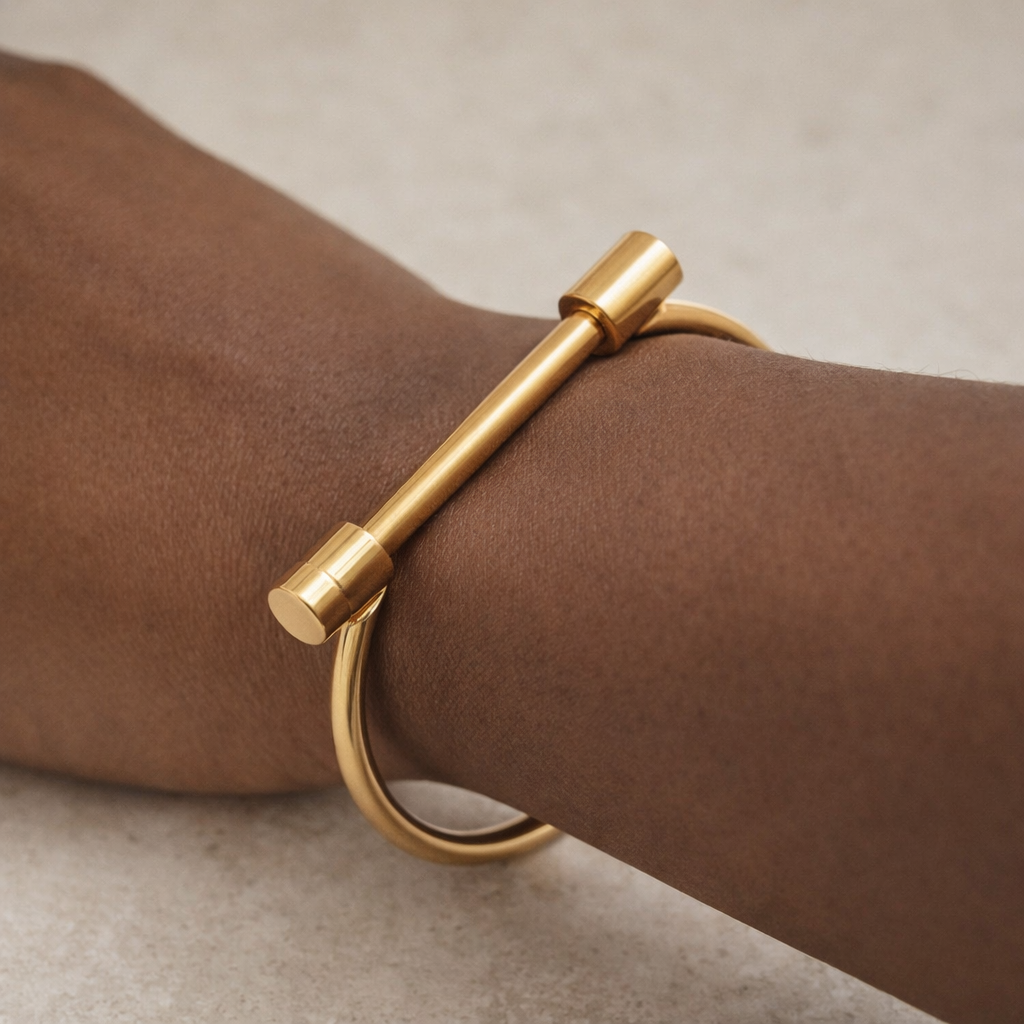 Minimalist gold T-bar bangle worn on wrist with clean styling