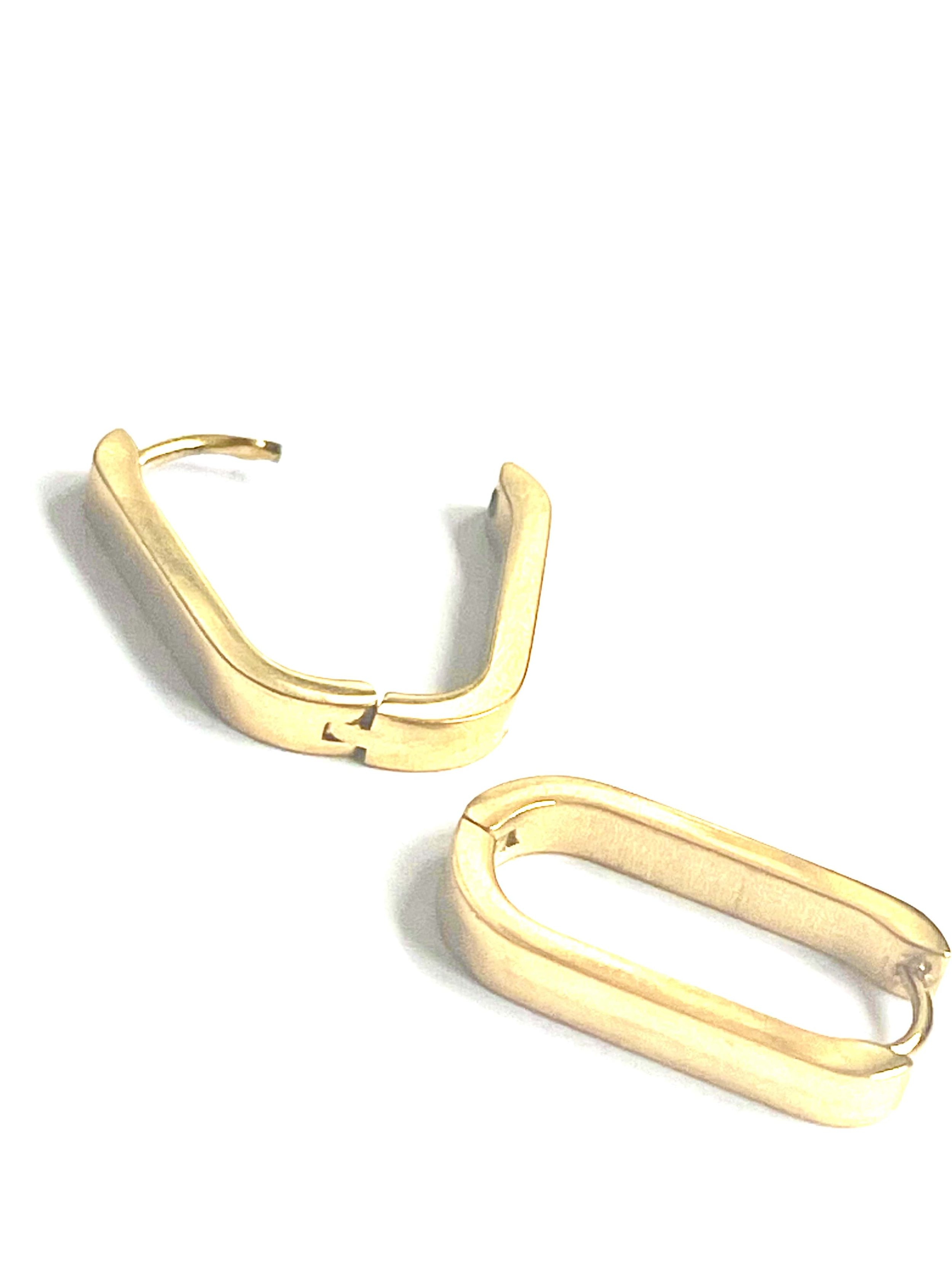 A snapshot revealing the versatile charm of the Capri huggies earrings, elegantly crafted to be worn in bold stacks or as understated individual pieces