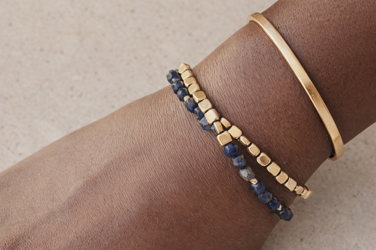 Petra lapis lazuli bracelet worn on wrist with tailored styling