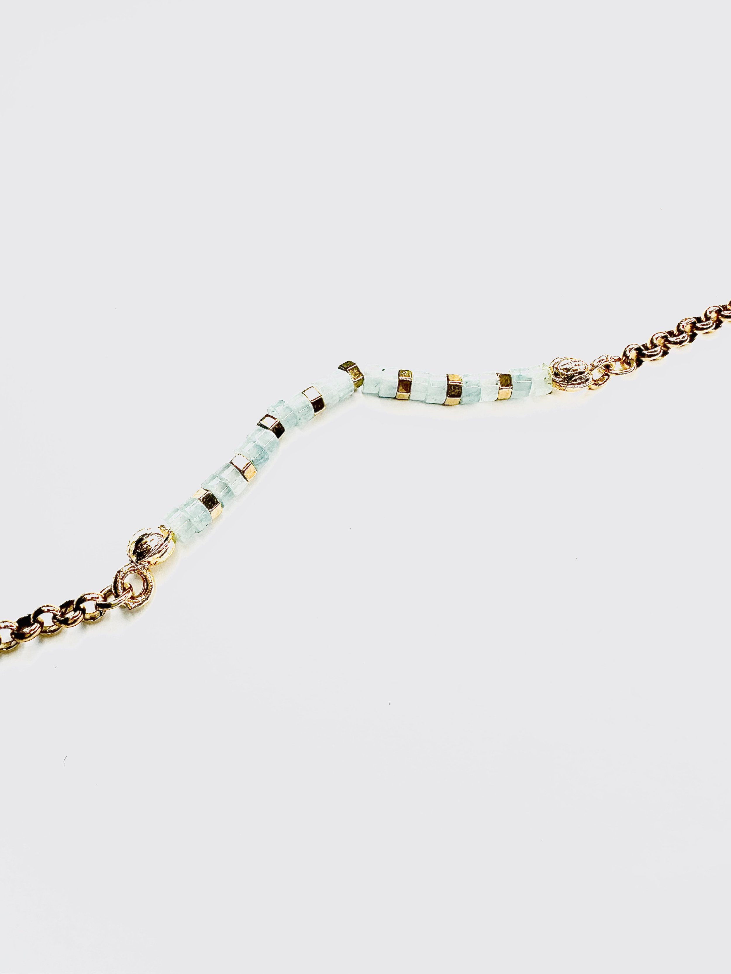 The bracelet worn by a model, its tranquil aquamarine tones complementing casual and formal attire.