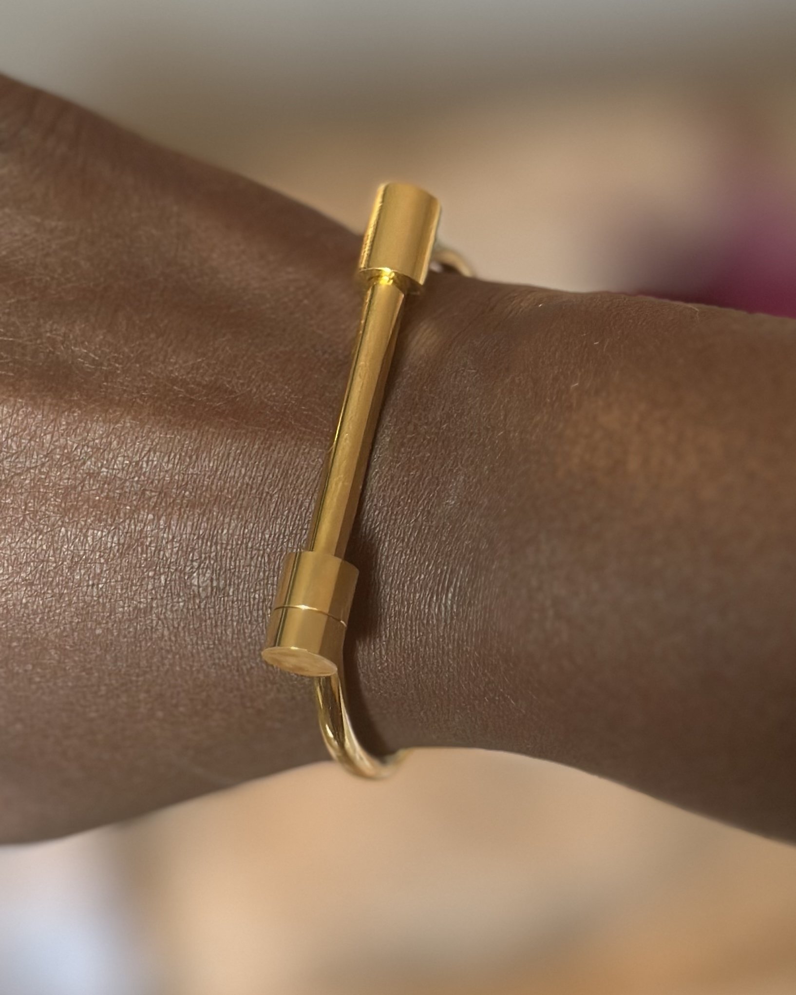 Minimalist goddess bangle styled on wrist