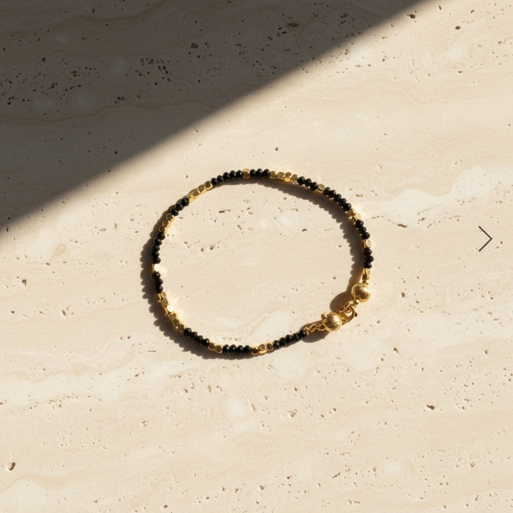 Close-up of black spinel beads and gold tone accents on Ibiza bracelet