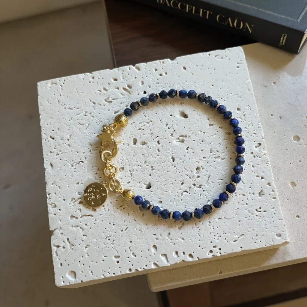 Close-up of lapis lazuli beads showing deep blue tones with gold-toned spacers