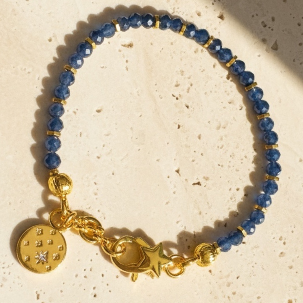 Celeste sapphire bracelet showing gold celestial charm with cubic zirconia