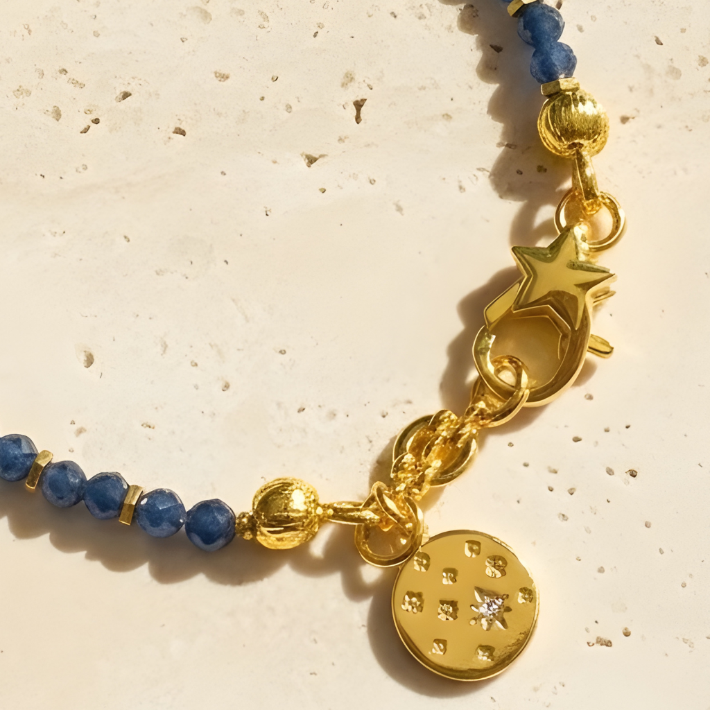 Faceted sapphire bracelet with gold-toned spacers and star clasp on light background