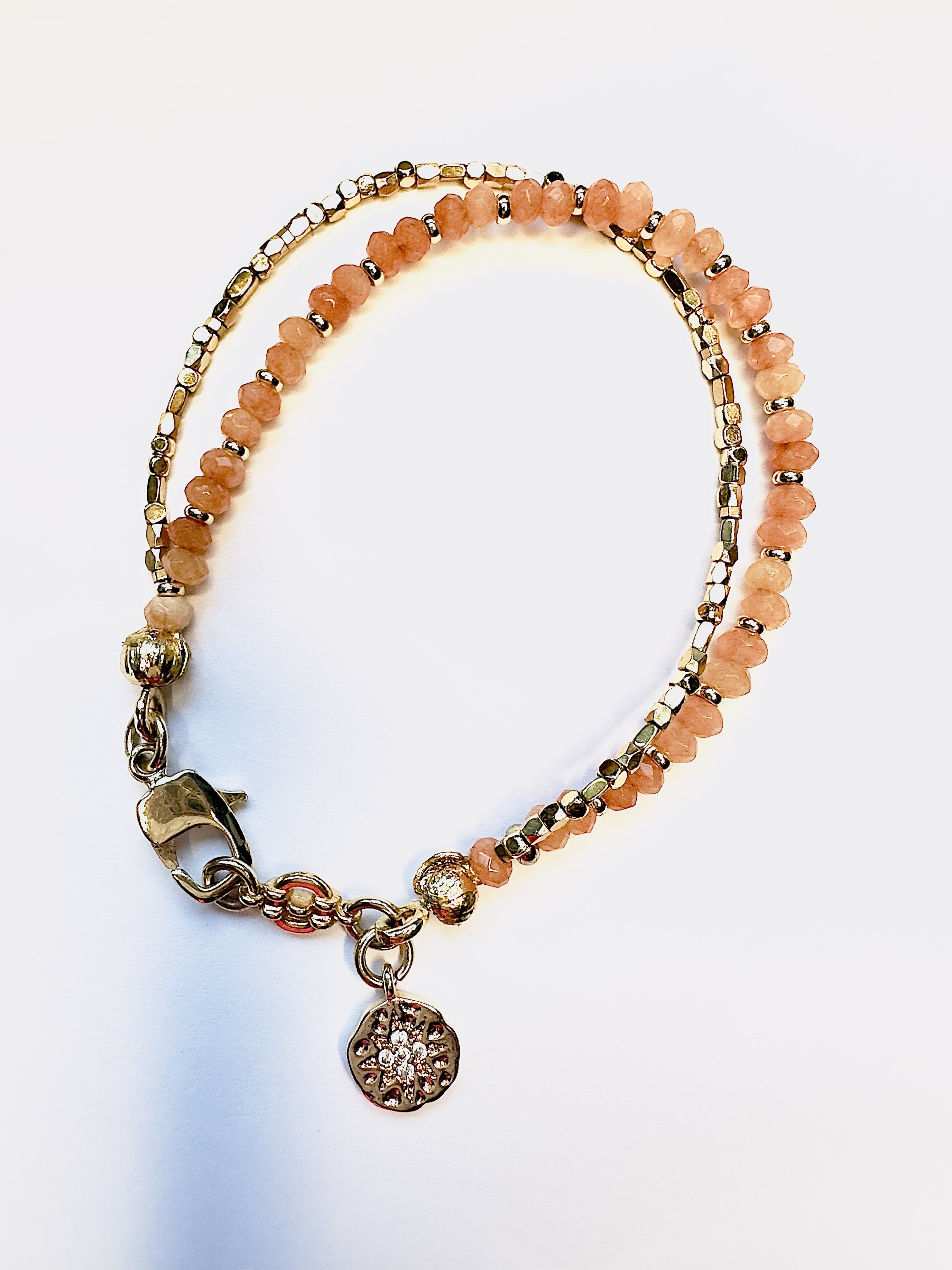 Close-up of polished orange calcite beads on the Ariadne Bracelet, highlighting their warm, sunny hues and smooth texture for a bold and vibrant look