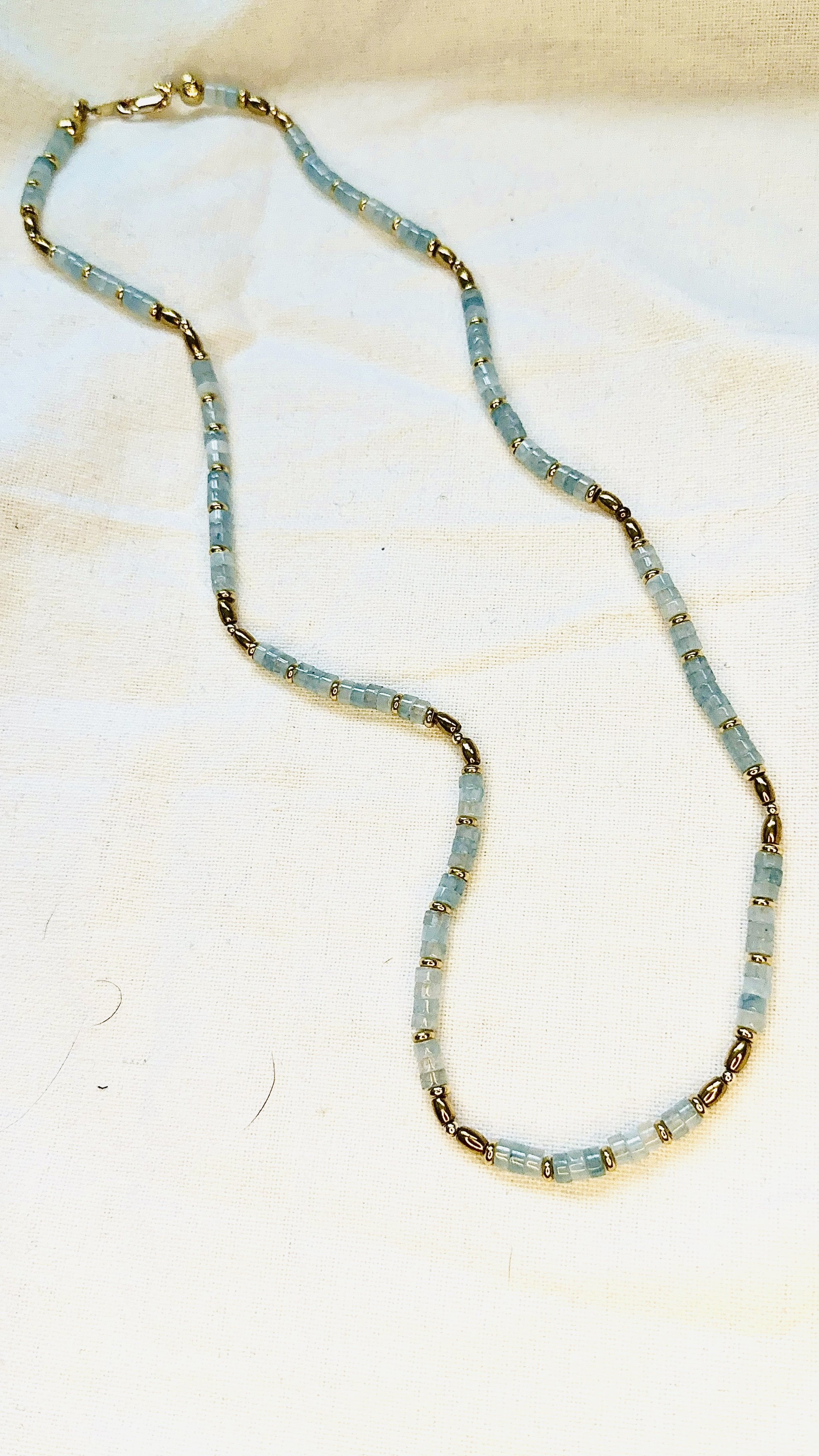 Coco Necklace with lab-made Aquamarine heishi beads and 18k gold plated haematite spacer beads, blue minimalist layering necklace by ÎLE KEKERE