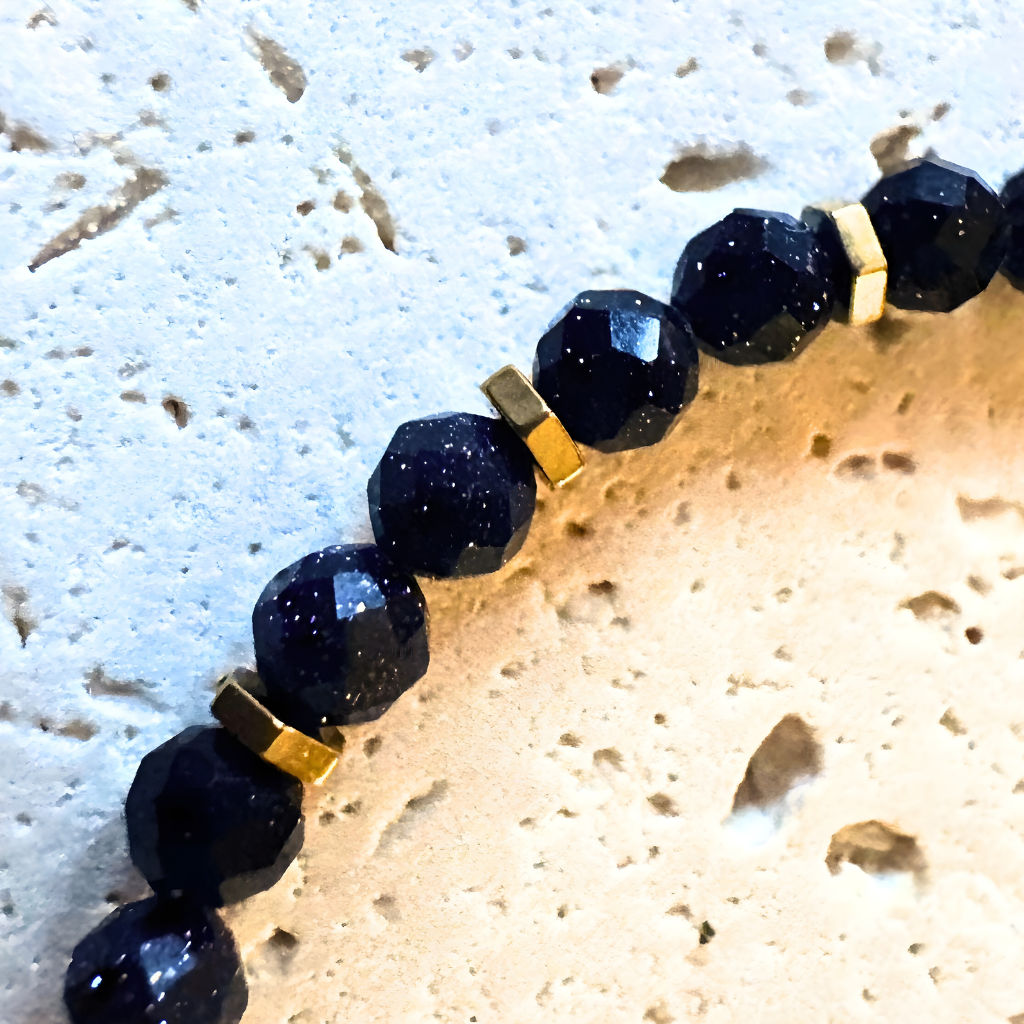 Close-up of blue sandstone beads showing subtle shimmer with gold-toned spacers
