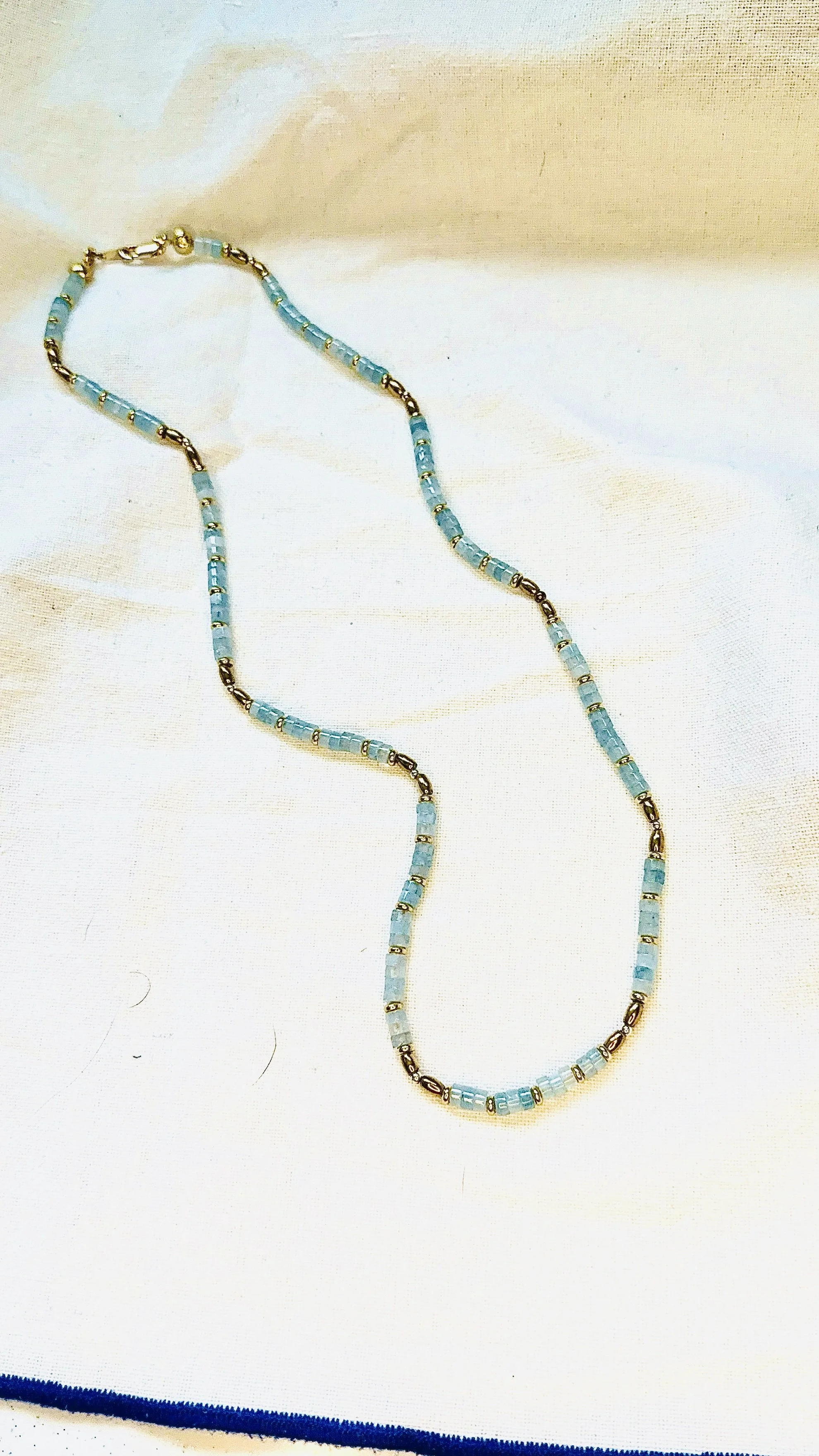 Coco Necklace with lab-made Aquamarine heishi beads and 18k gold plated haematite spacer beads, blue minimalist layering necklace by ÎLE KEKERE