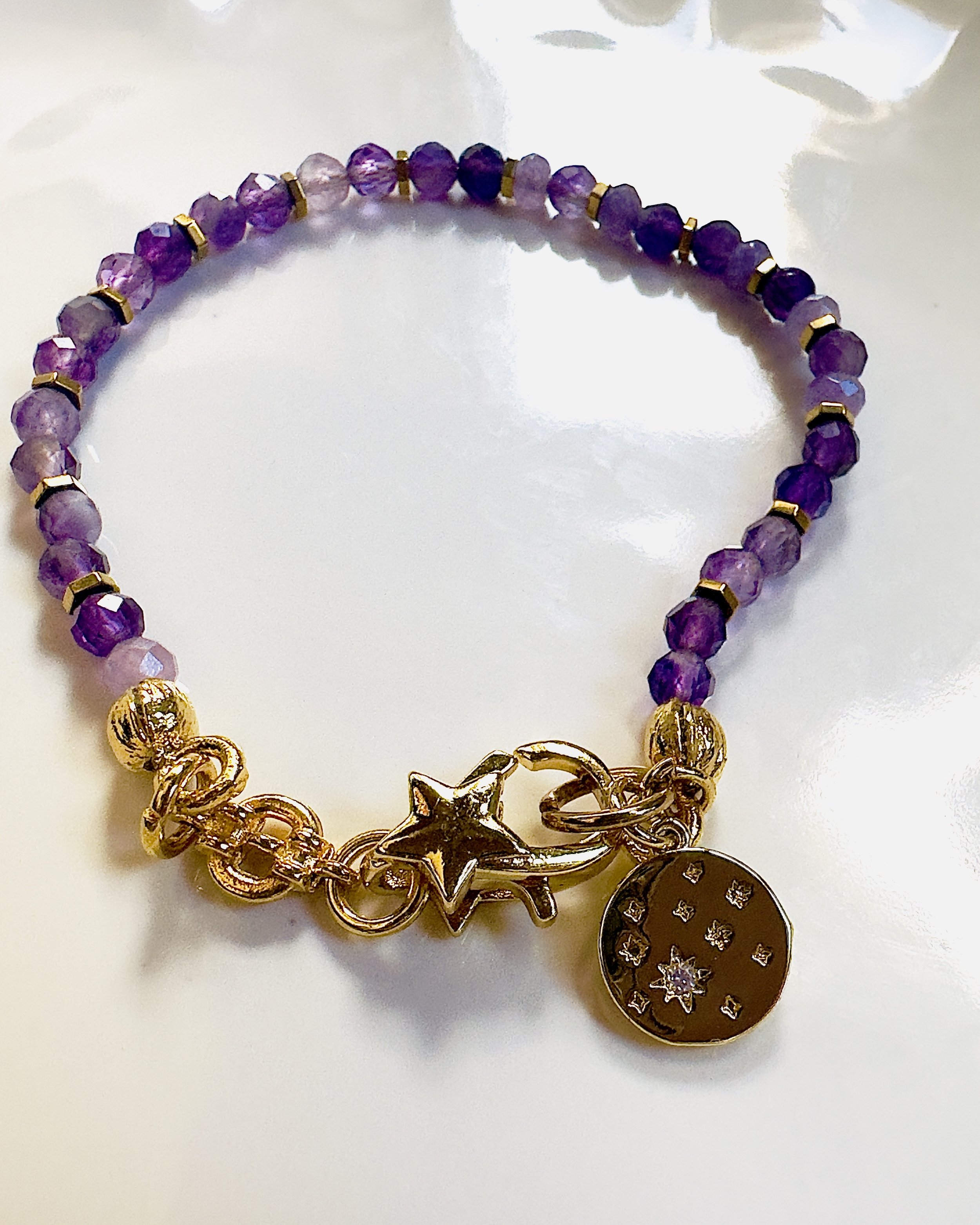 Close-up of Amethyst beads on the Celeste Bracelet, showcasing their deep purple hues and smooth, polished finish for an elegant and calming look