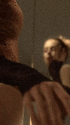 A person holding a lighter near their face with a blurred background.