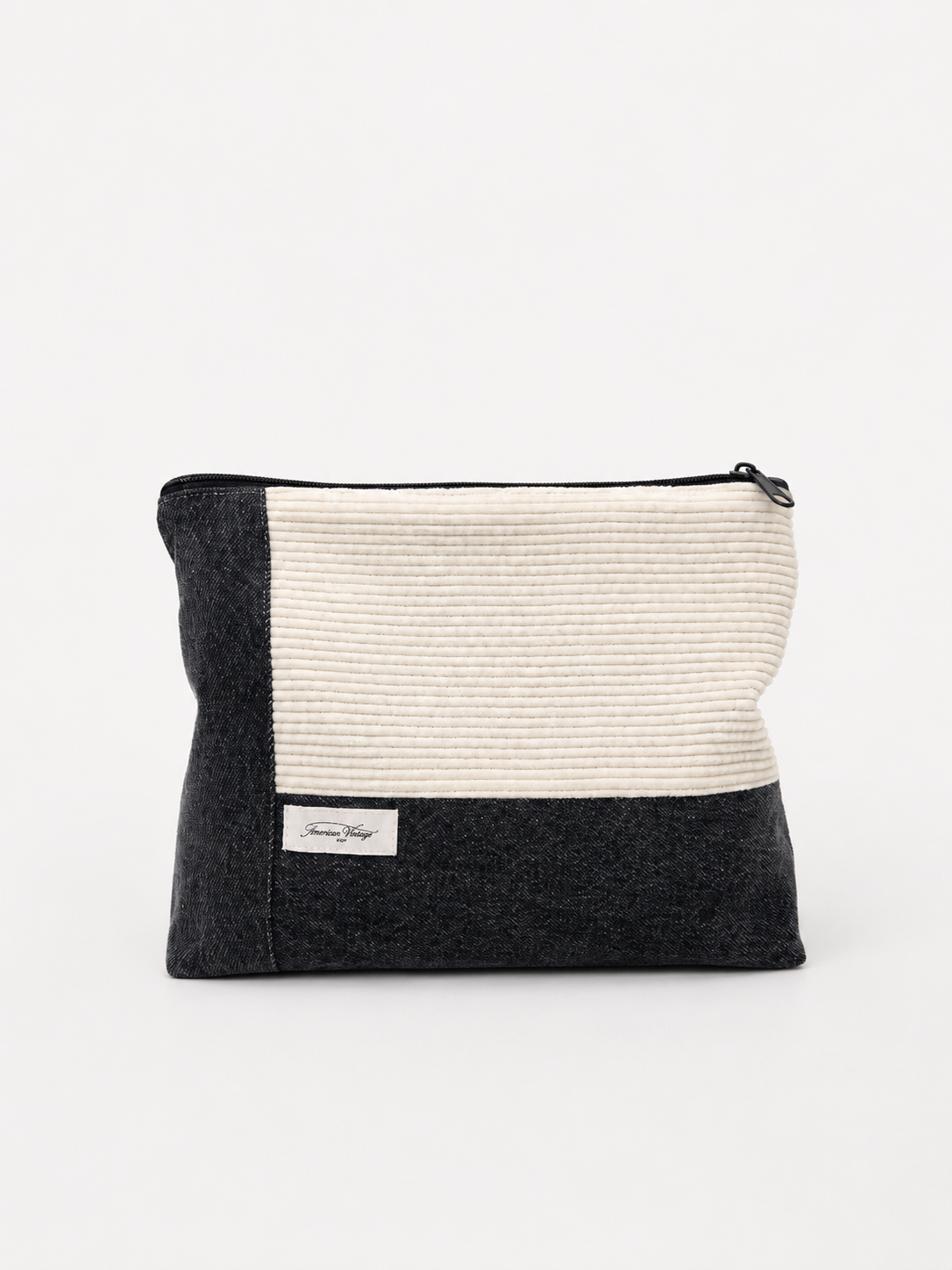Sac de voyage à motifs noir et blanc avec une étiquette 'American Vintage' sur le devant, placé sur un fond blanc.