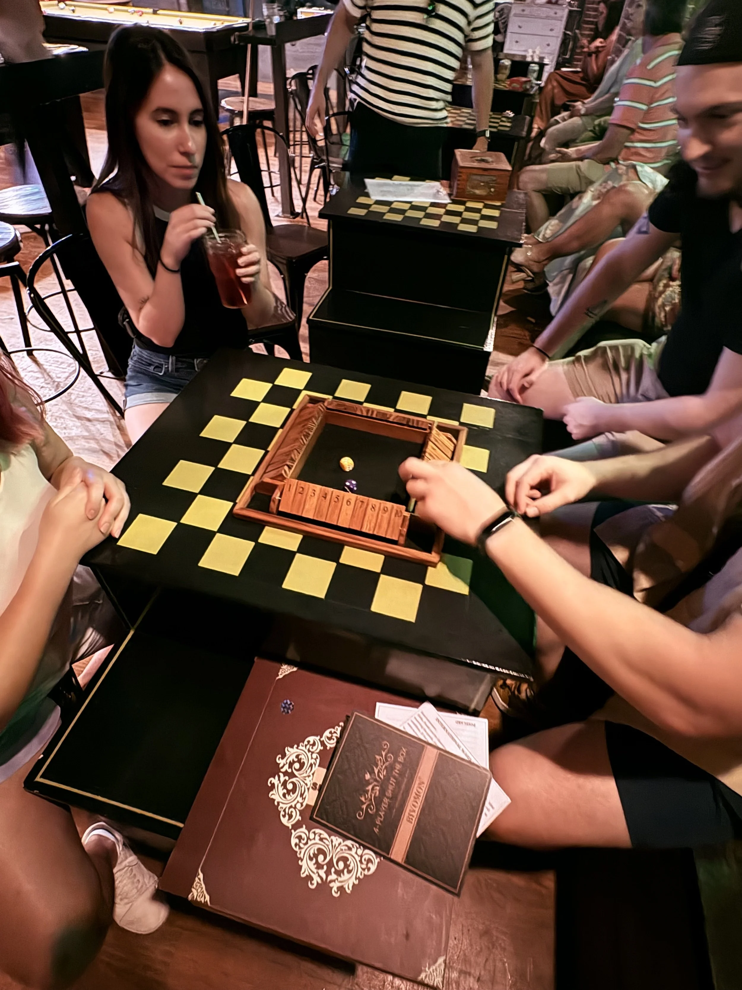Guests enjoying games at Chartreuse Saloon, a popular hang and date night spot in Kansas City.