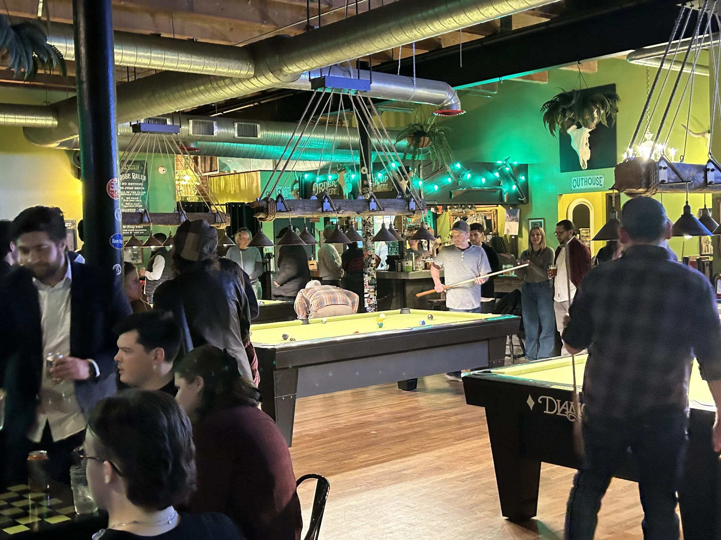 Guests enjoying FREE pool on 9 Ft. Diamond pool tables at Chartreuse saloon, a popular pool/nightlife spot in Kansas City, MO.