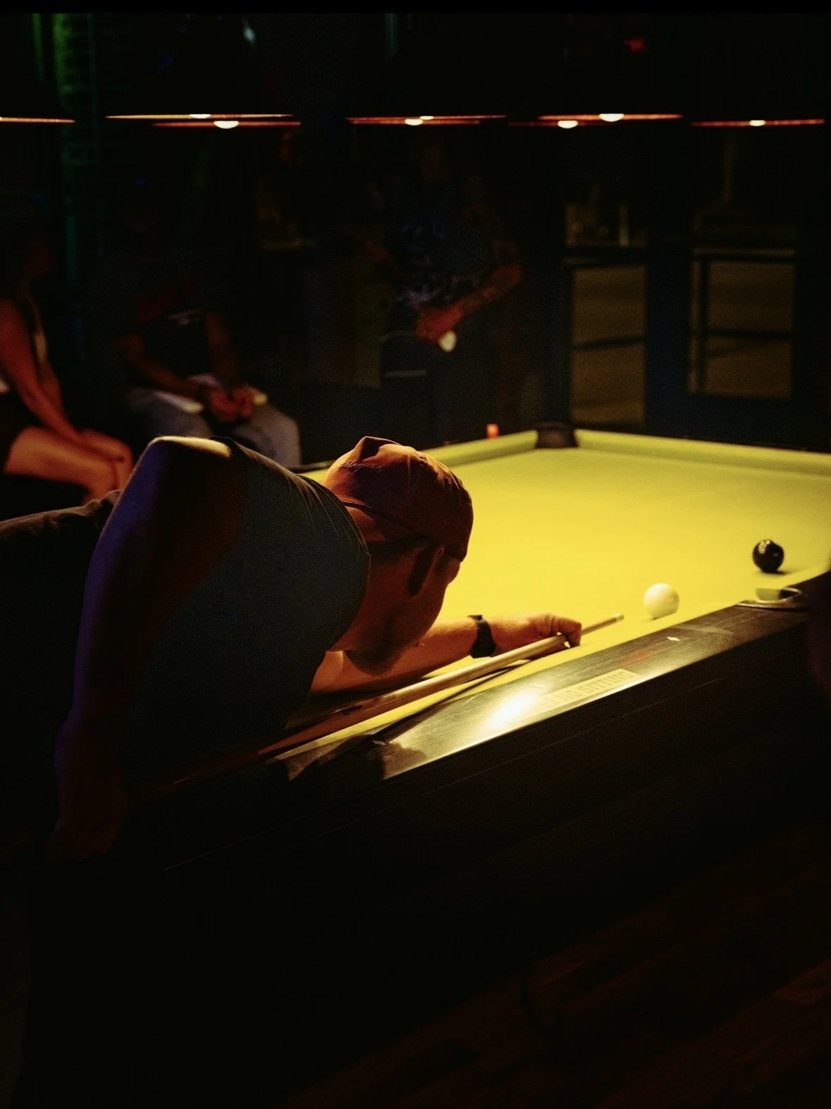 A regular taking his shot at the eight ball on our 9 ft. Diamond tables at Chartreuse Saloon in Kansas City.