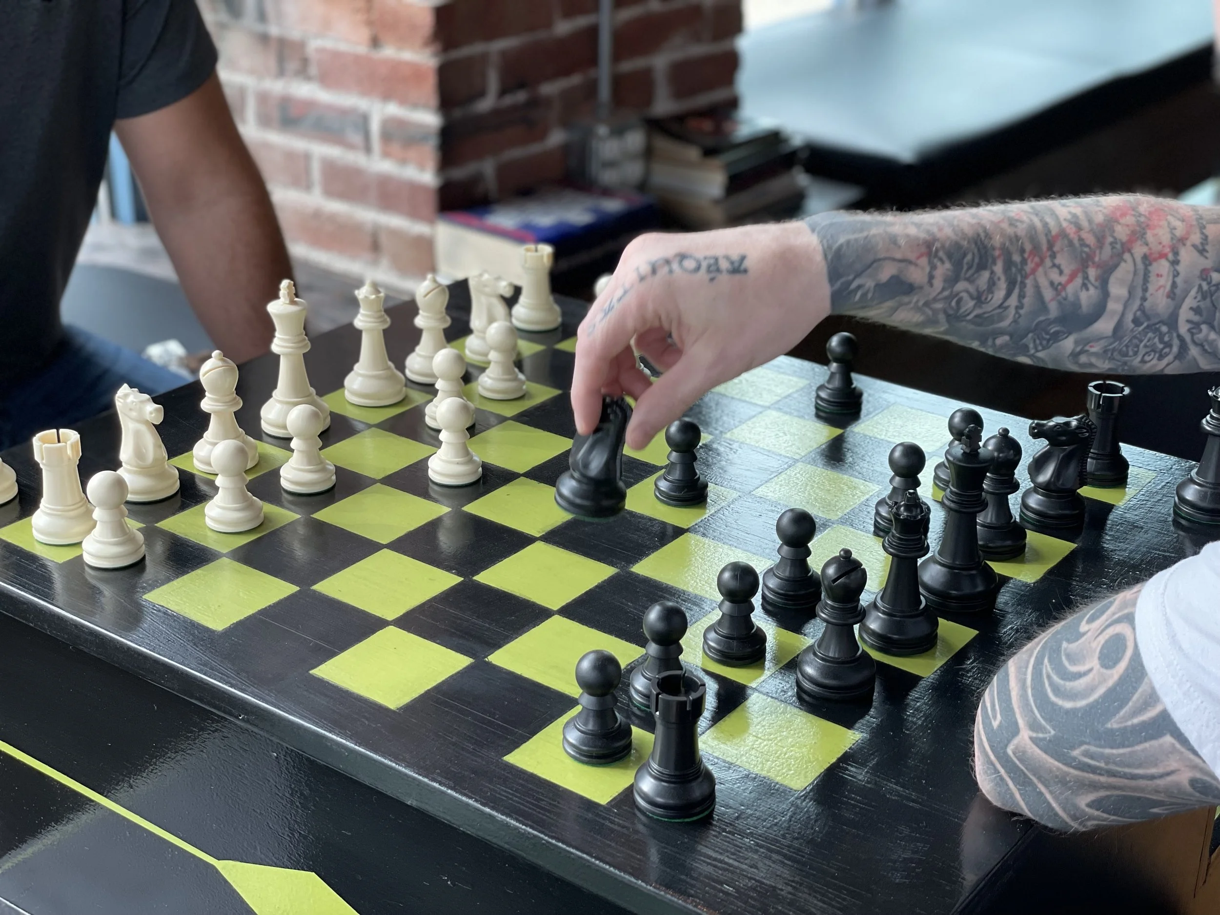 Guests enjoying a friendly game of chess at Chartreuse Saloon in Kansas City