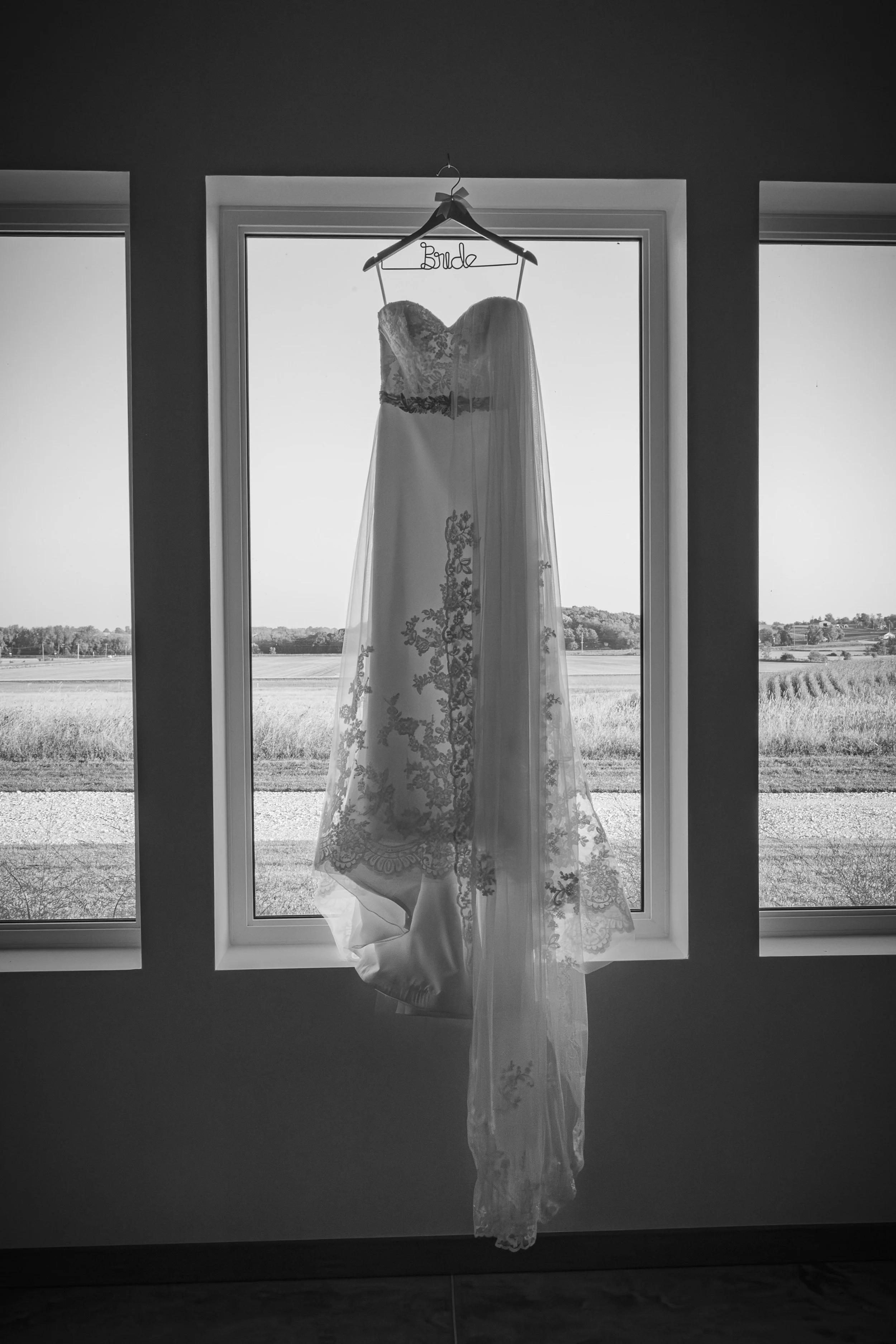 White Knot Barn Brides Dress over Window.jpg