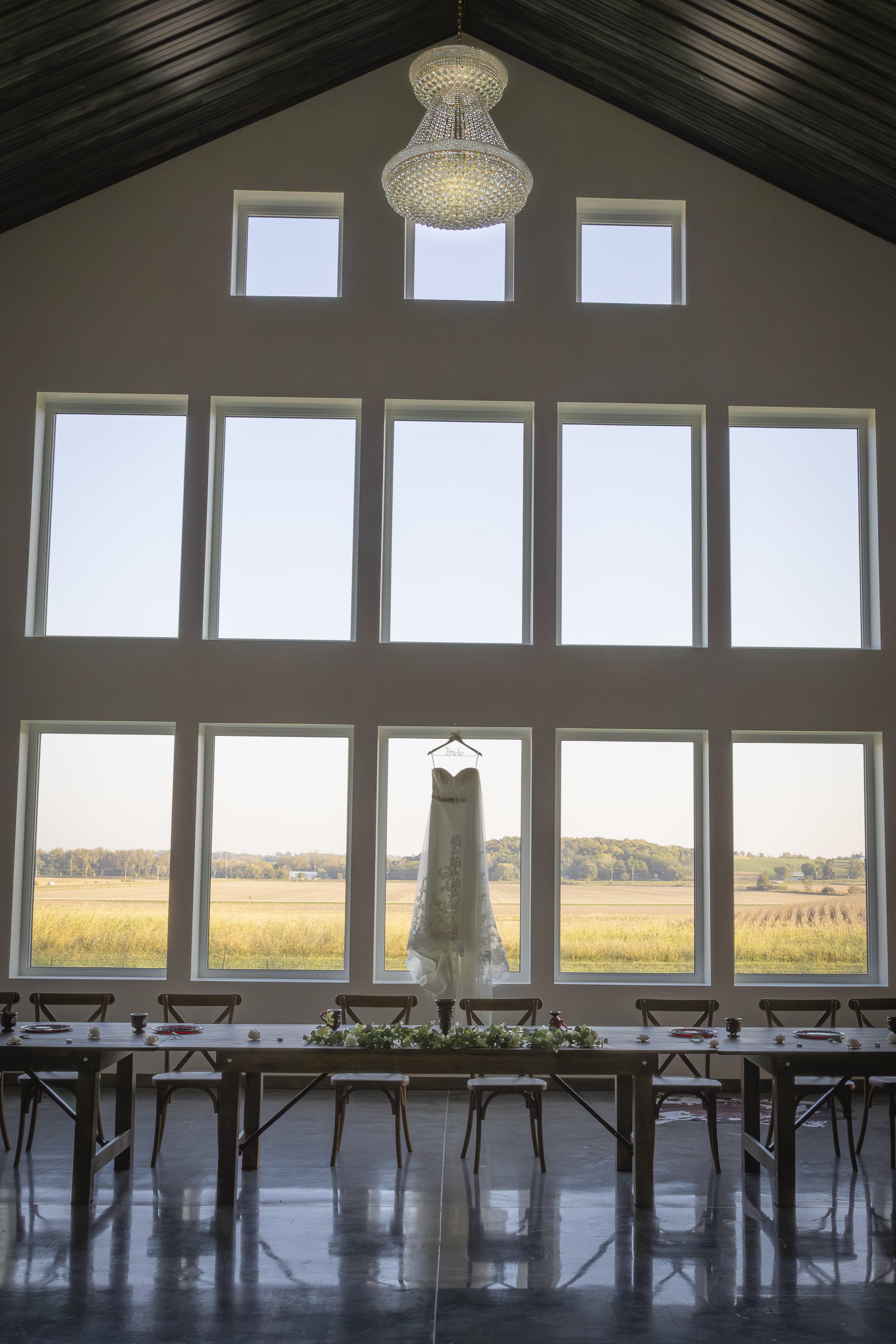 White Knot Barn Bride Wedding Dress with Chandelier.jpg