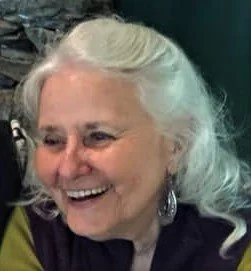Smiling elderly woman with white hair and earrings