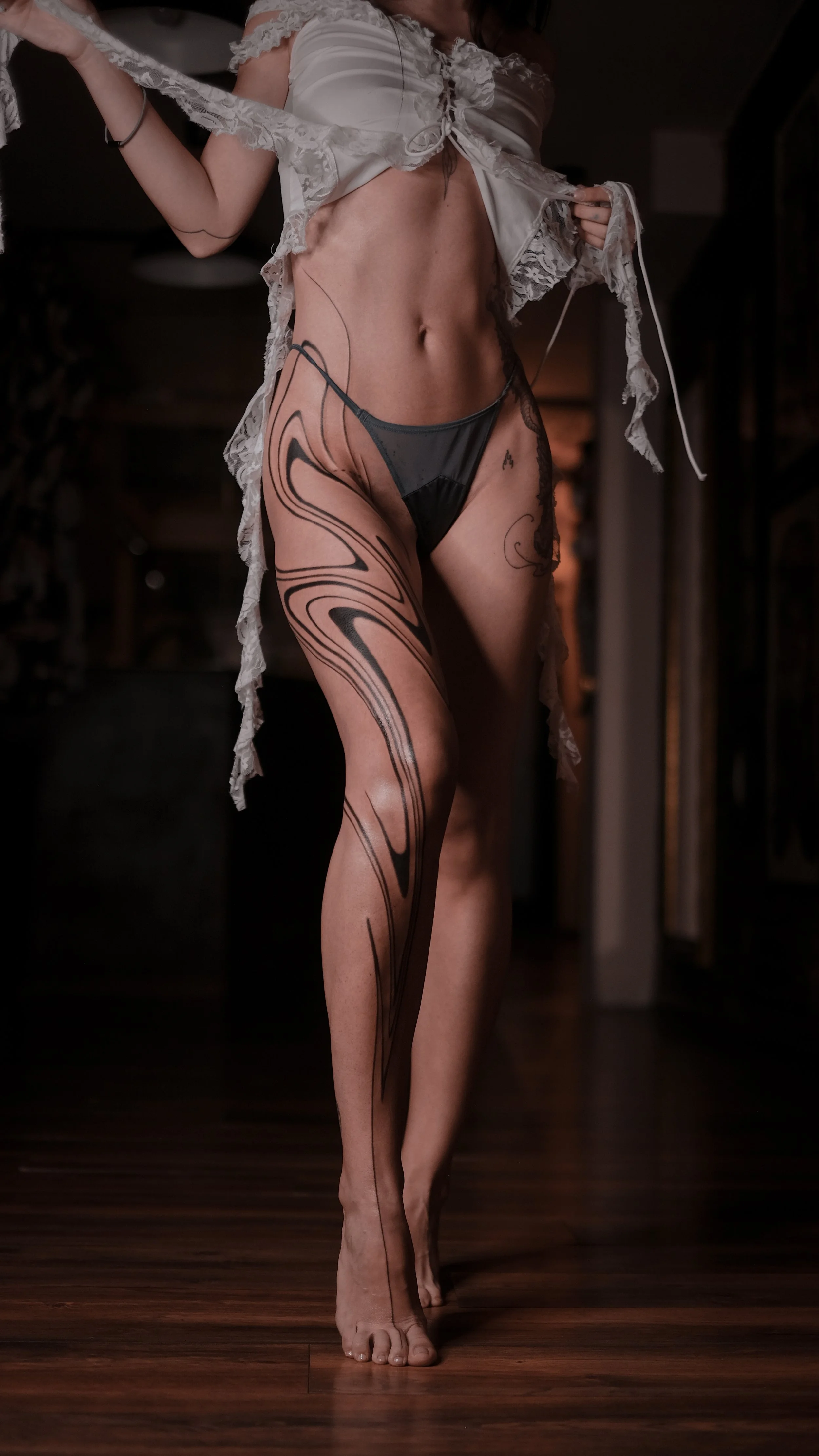 Woman in lingerie with tattoo design on leg