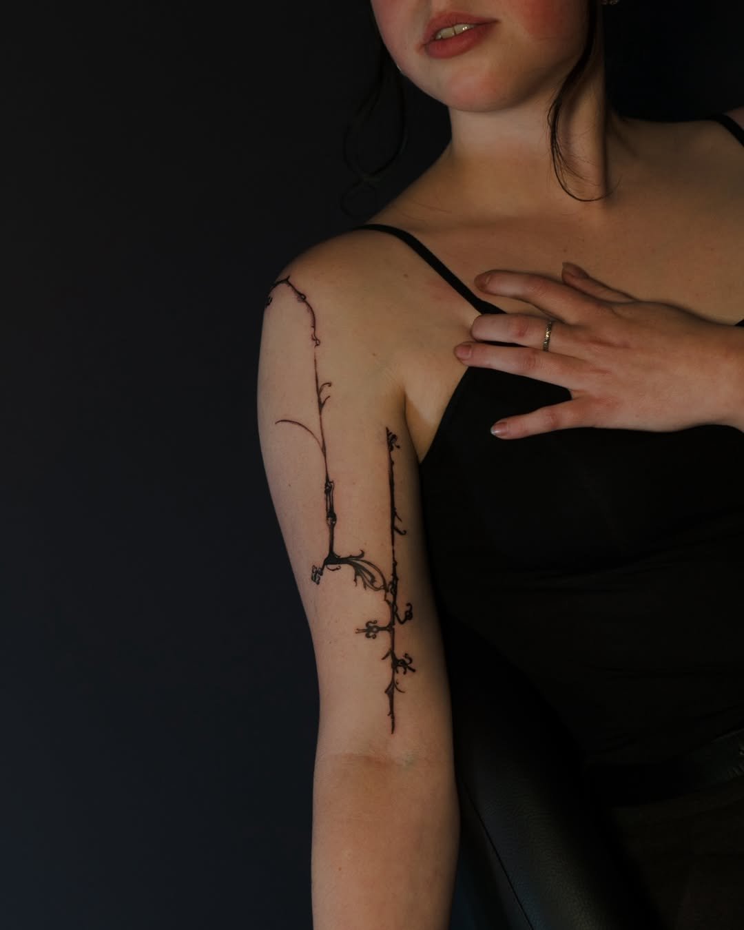 Person with botanical tattoo on arm