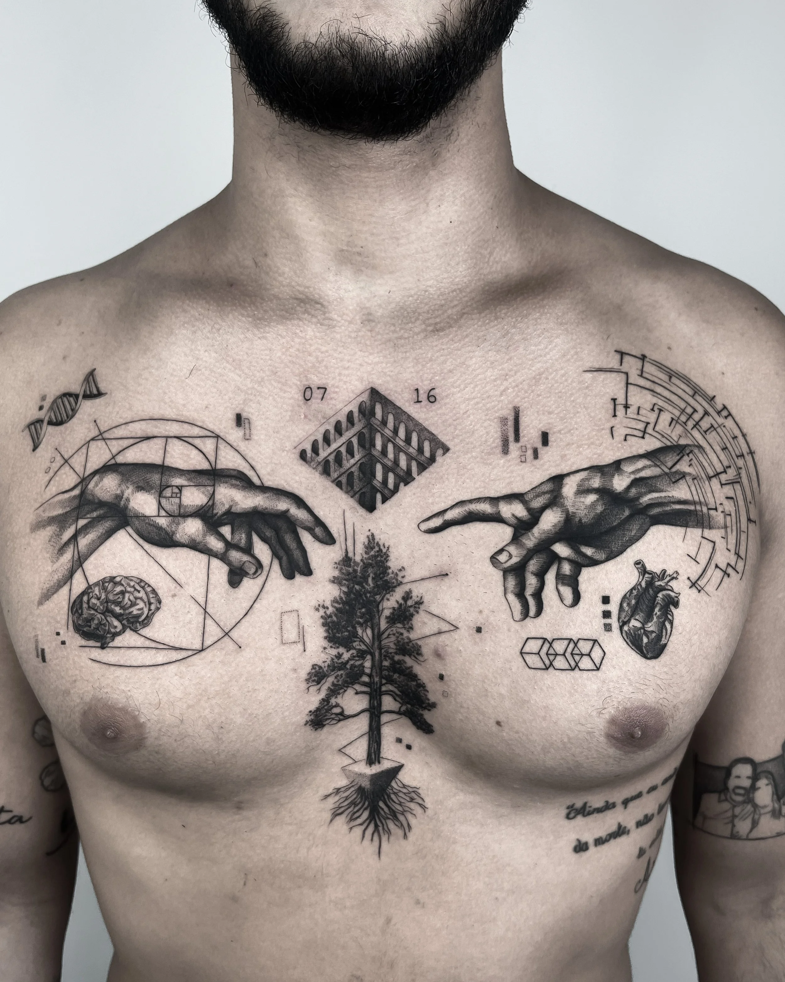 A man's chest featuring tattoos of two hands reaching out, a geometric design, a brain, a heart, a tree with roots, DNA helix, numbers "07" and "16," and abstract patterns.