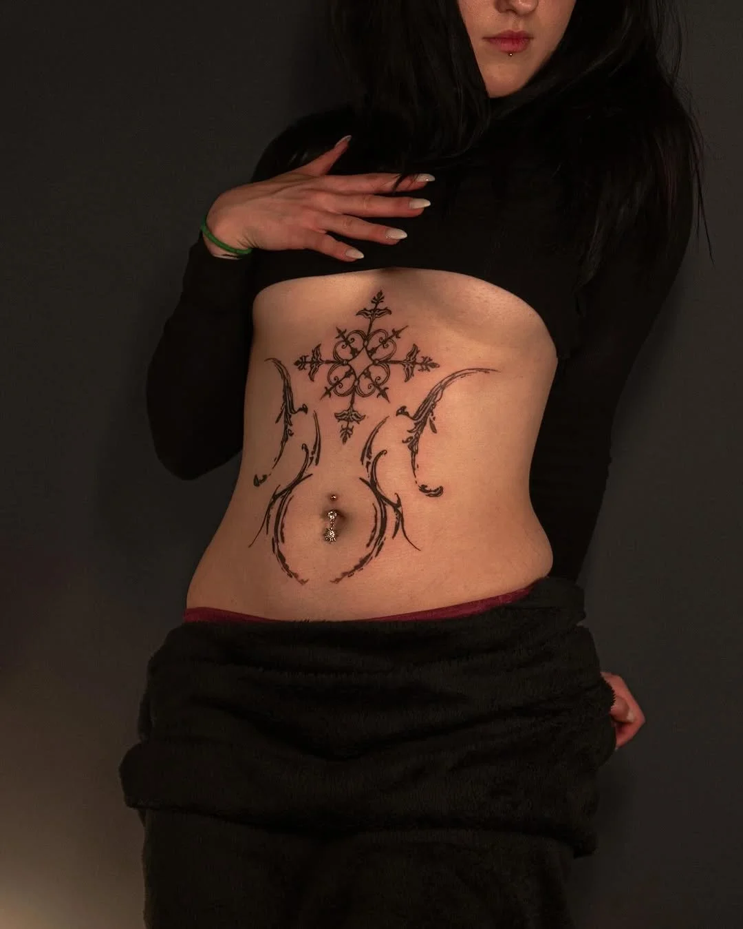 Person with decorative henna tattoo on midriff