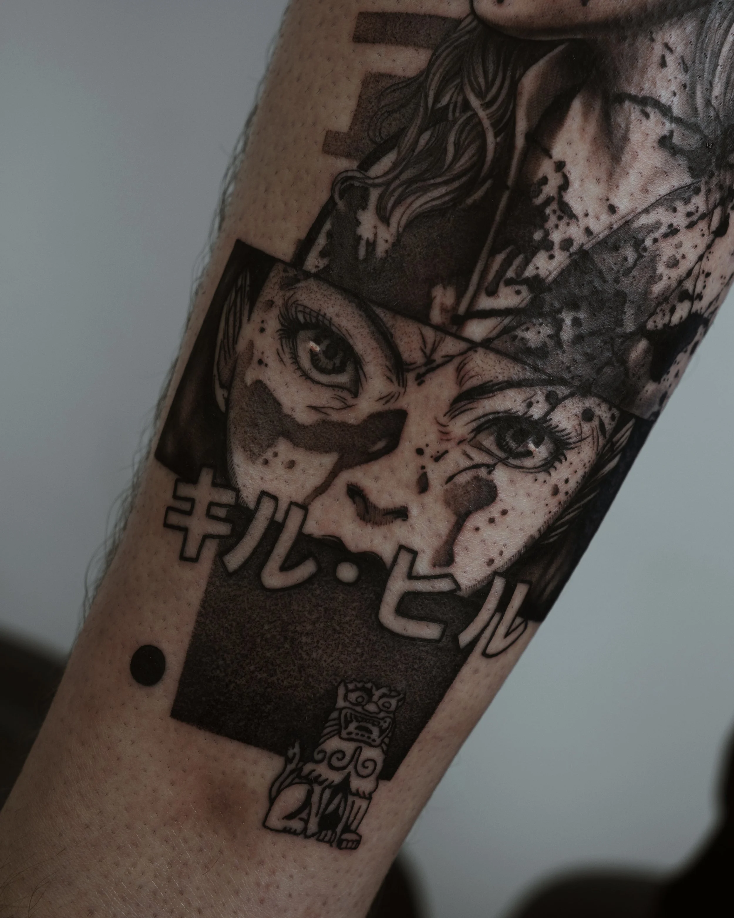 Tattoo featuring a detailed illustration of a woman's face in a comic style, with Japanese characters and a small mythical creature design below.