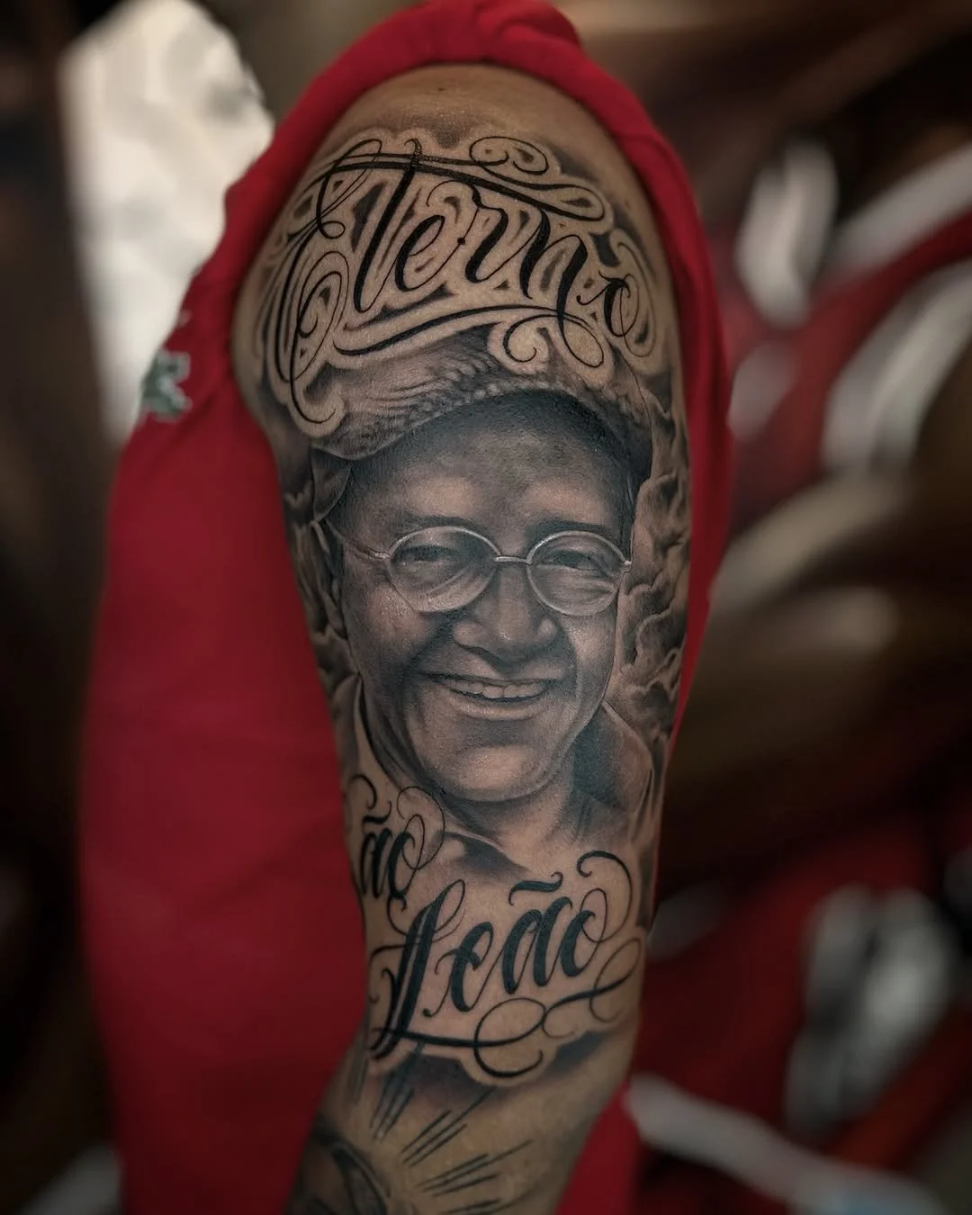 Tattoo of a smiling older man with glasses, with the words 'Forever' and 'Léa' tattooed above and below his face.