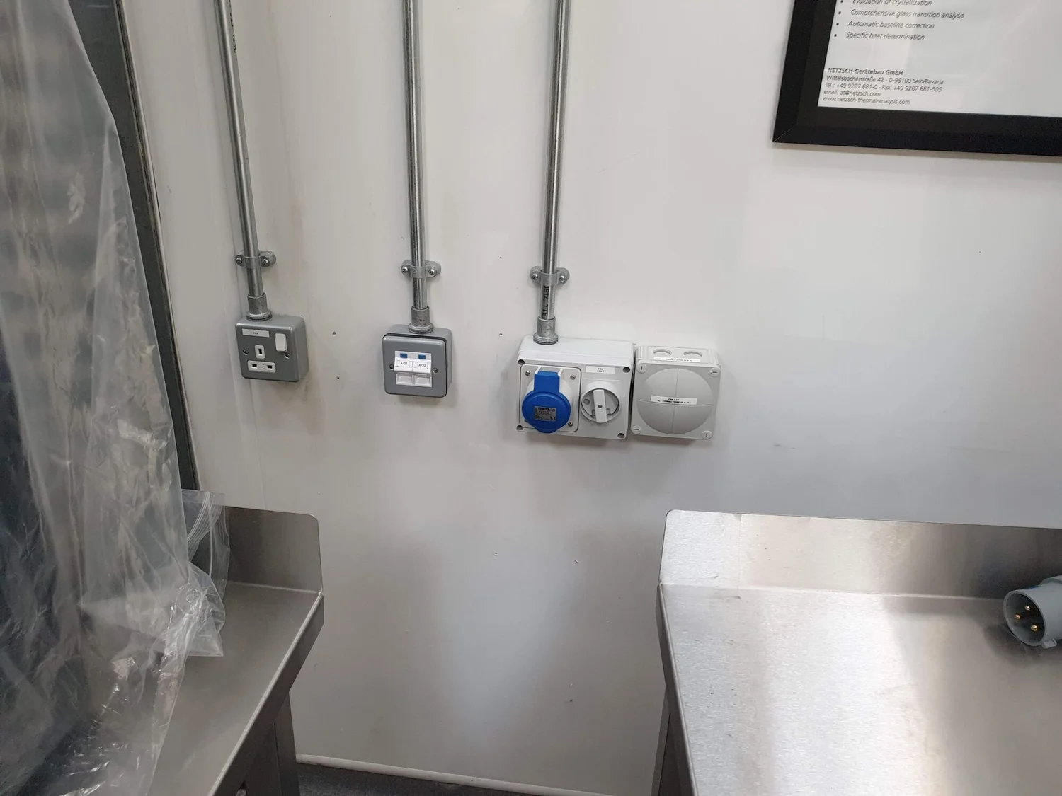 Galvanised conduit drops to metal-clad sockets and an industrial socket
