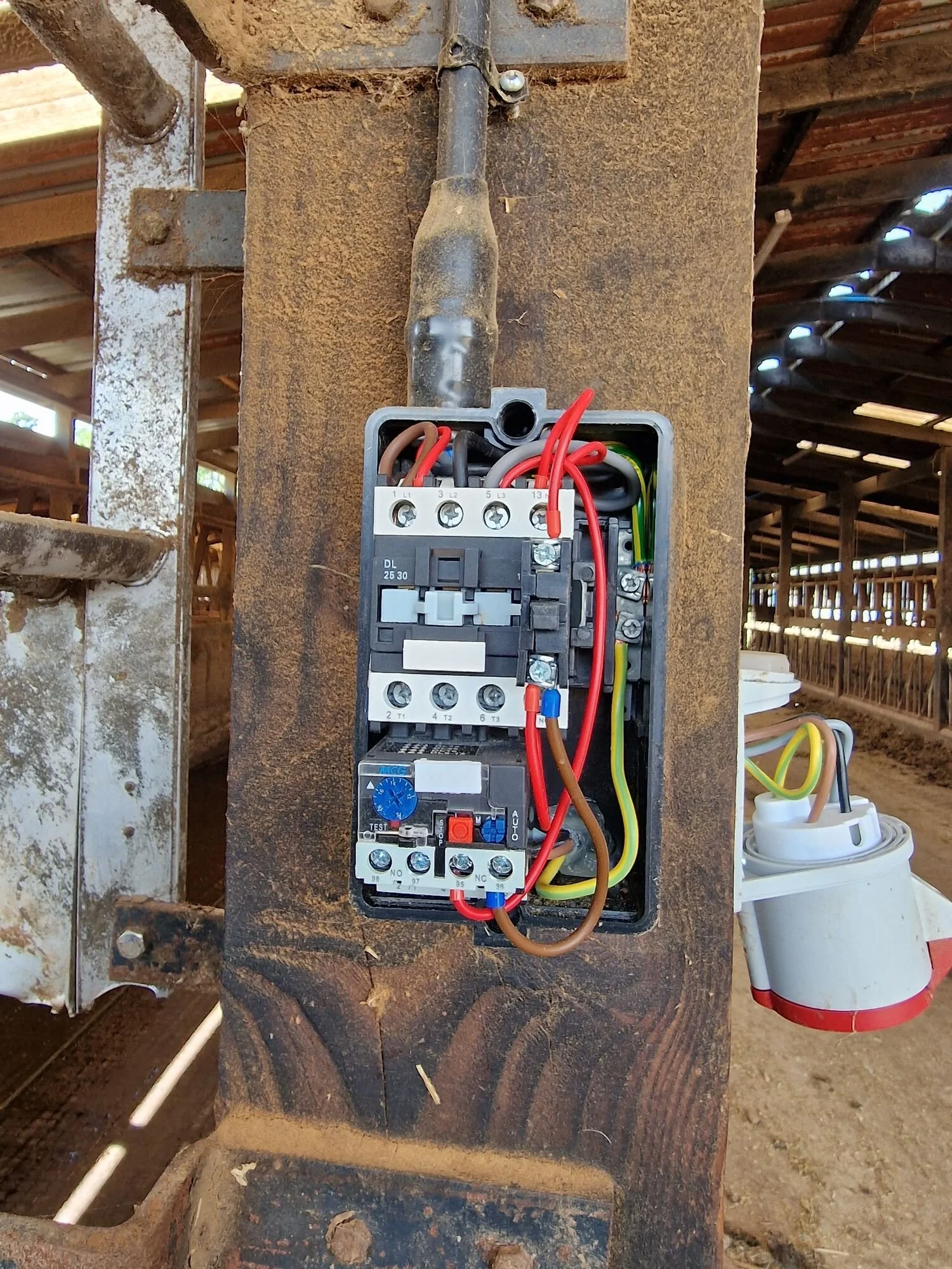 DOL motor starter with its cover off during repair work on a Leicestershire farm