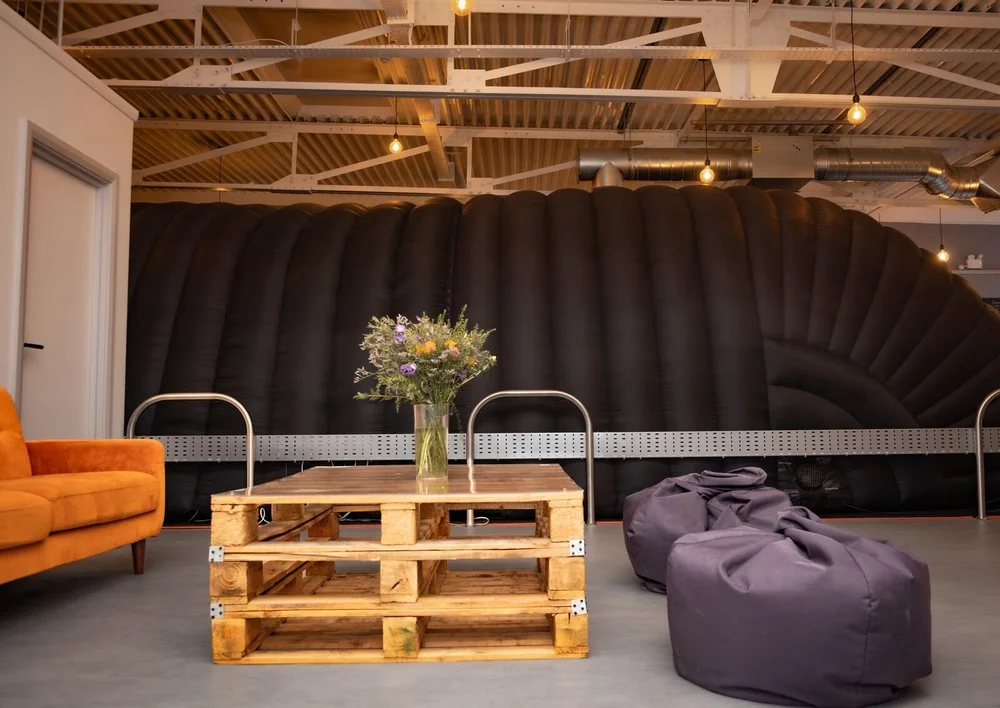 Finished Hot Pod Yoga studio lounge with pendant lighting, exposed ductwork and cable tray in a converted industrial unit, Leicester