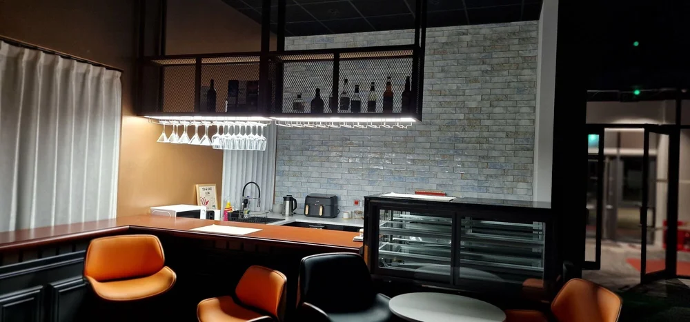 Bar and caf&eacute;-style break area with feature lighting in a new office fit-out, Kibworth