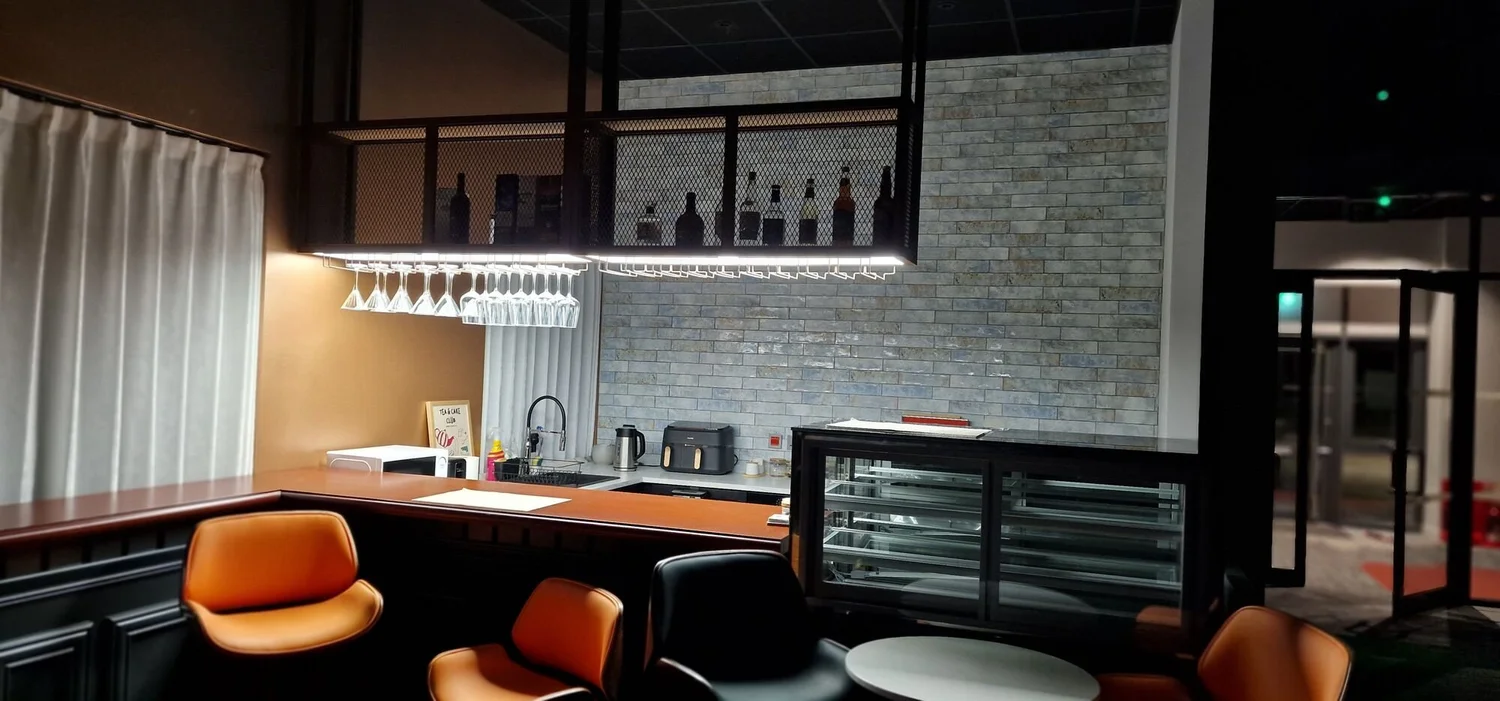 Bar and café-style break area with feature lighting in a new office fit-out, Kibworth