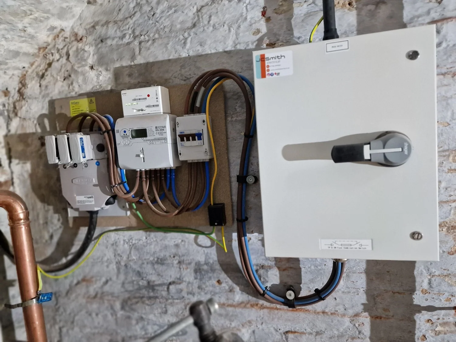 Main switch isolator and metering installed on a brick wall in a commercial building