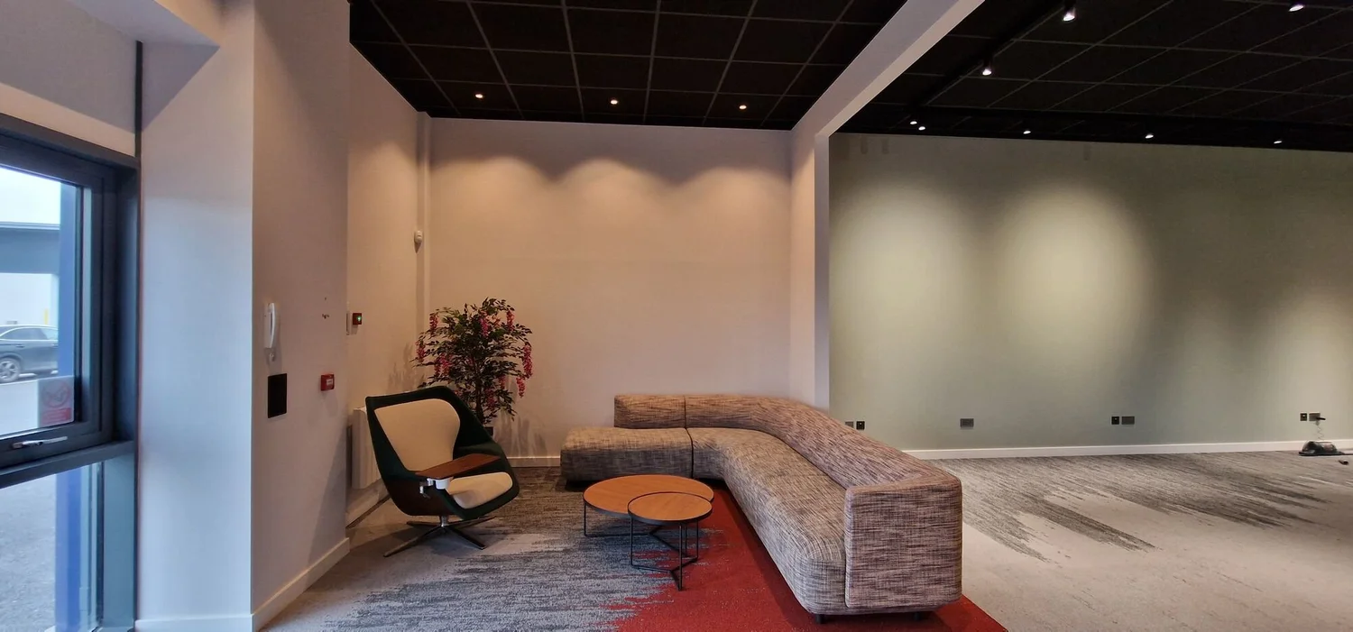 Showroom lounge with recessed downlights washing the walls in a converted industrial unit, Kibworth
