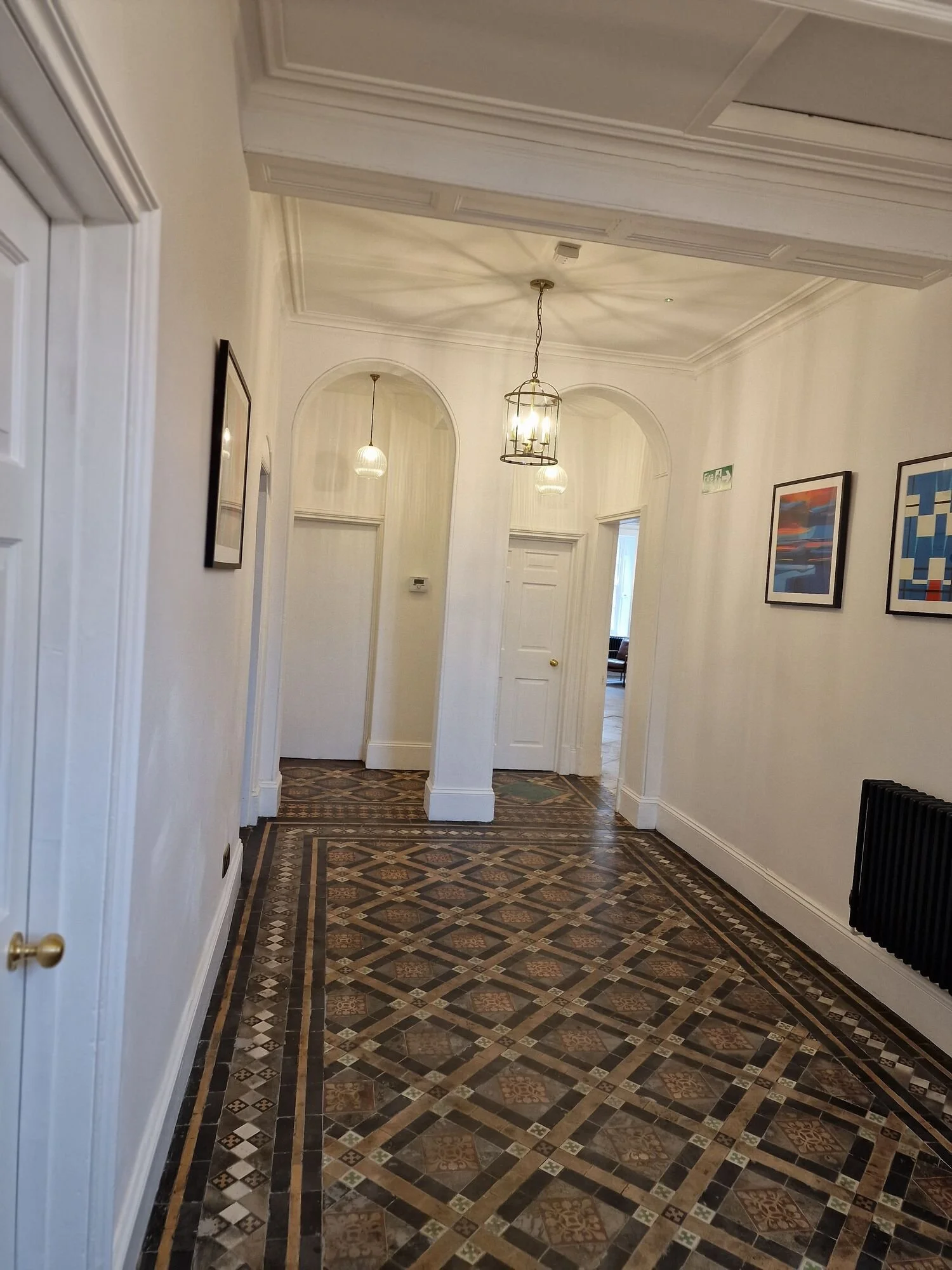 Finished hallway with period tiled floor and new lighting after an electrical refurbishment in a Leicester city-centre building