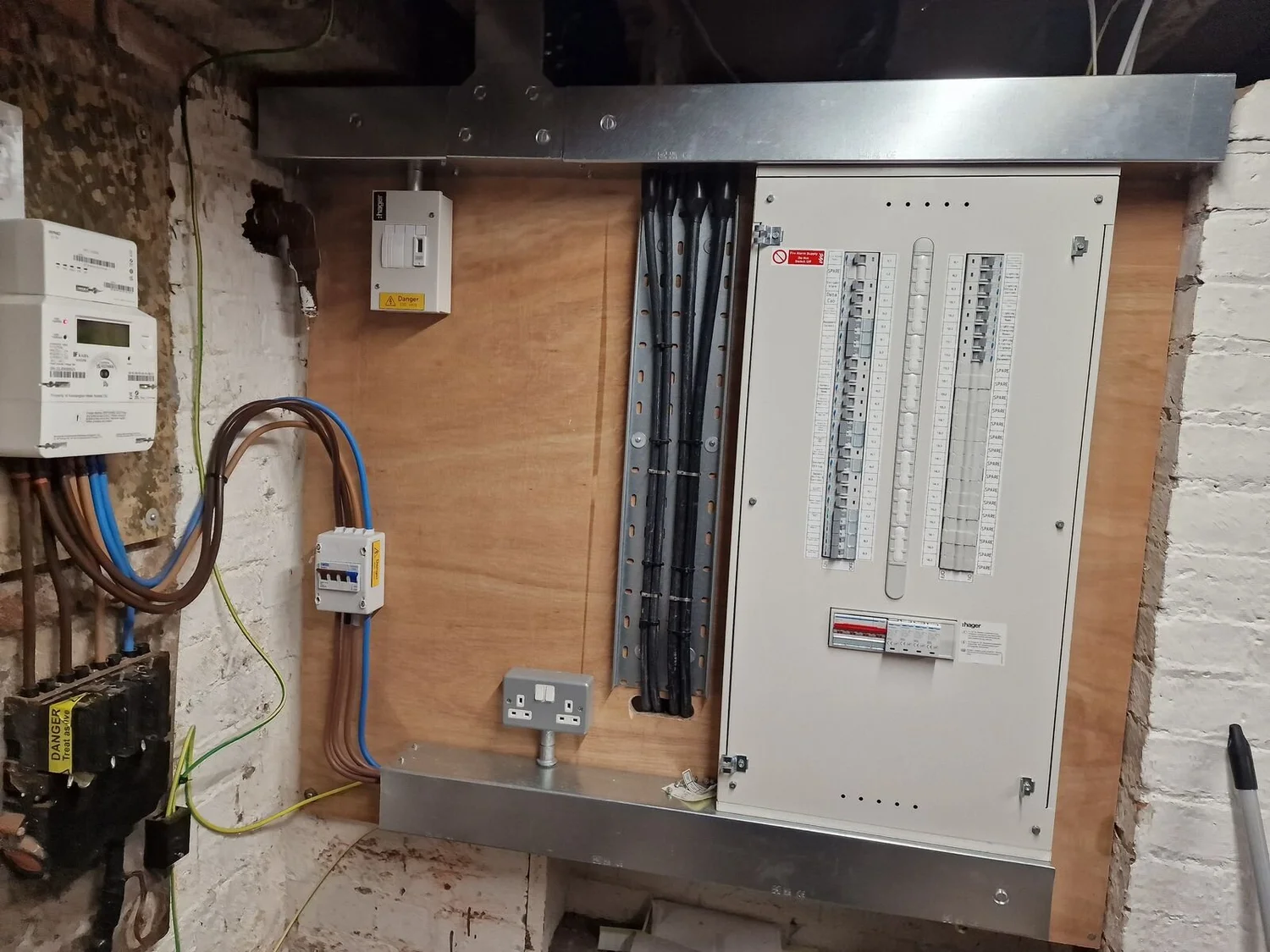 New distribution board with steel trunking on a plywood backboard at a Pilates studio, Leicester