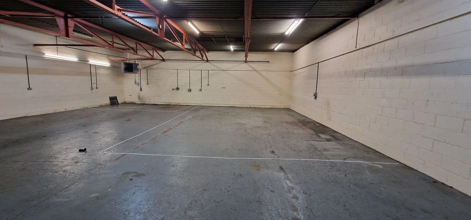 Empty industrial unit before an electrical fit-out for a hot yoga studio, Leicester