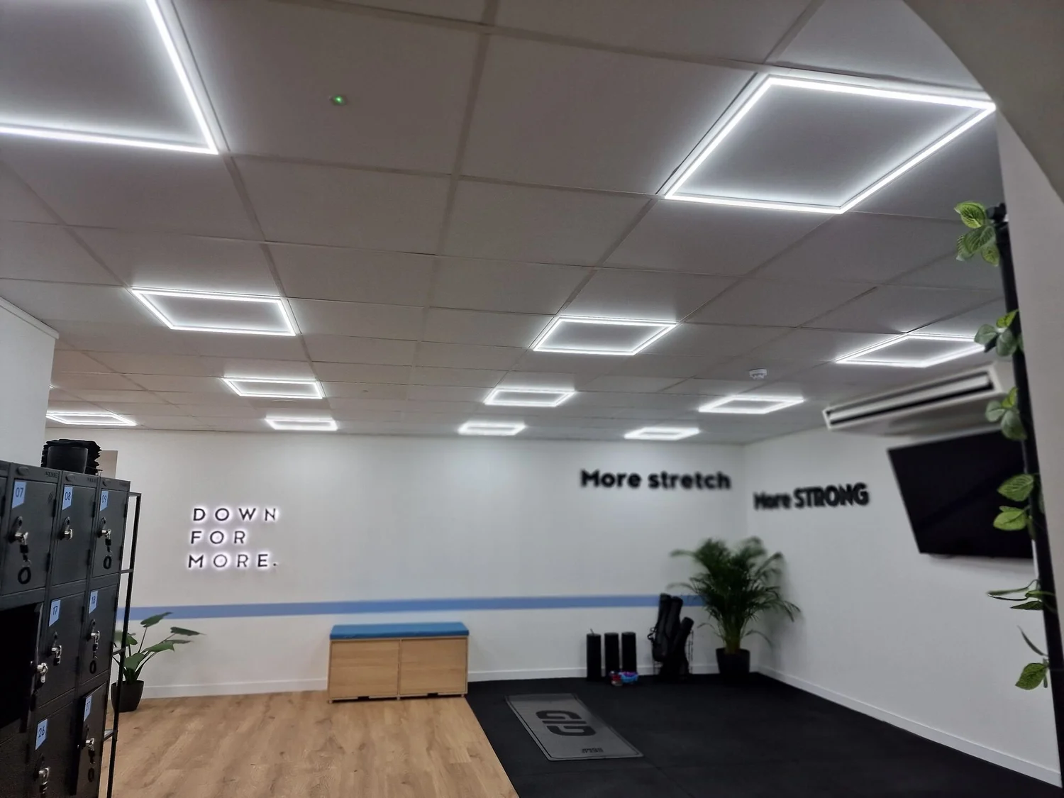 Square LED frame panels in the ceiling of a Pilates studio stretch area, Leicester