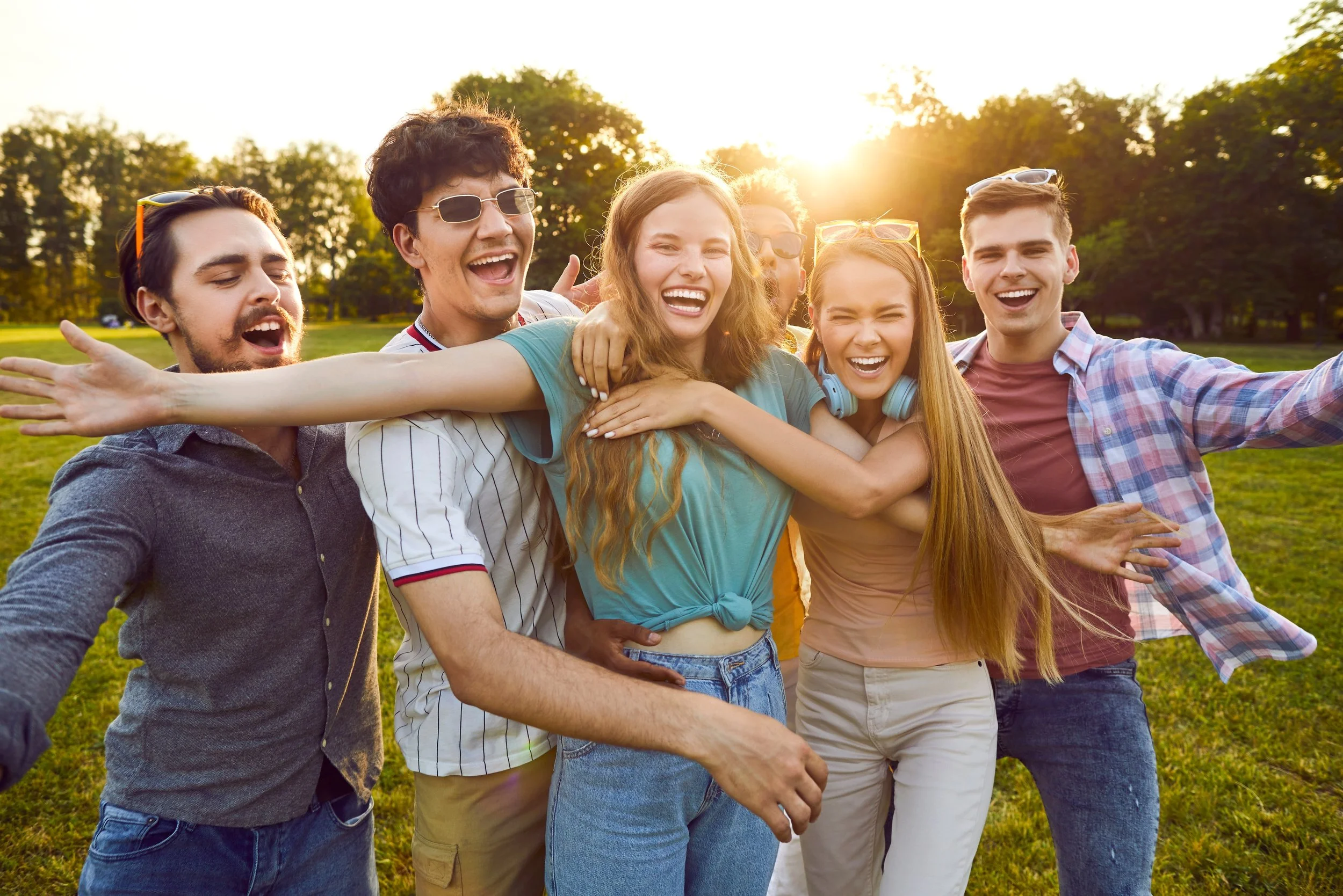 A group of young adults smiling after therapy in a park