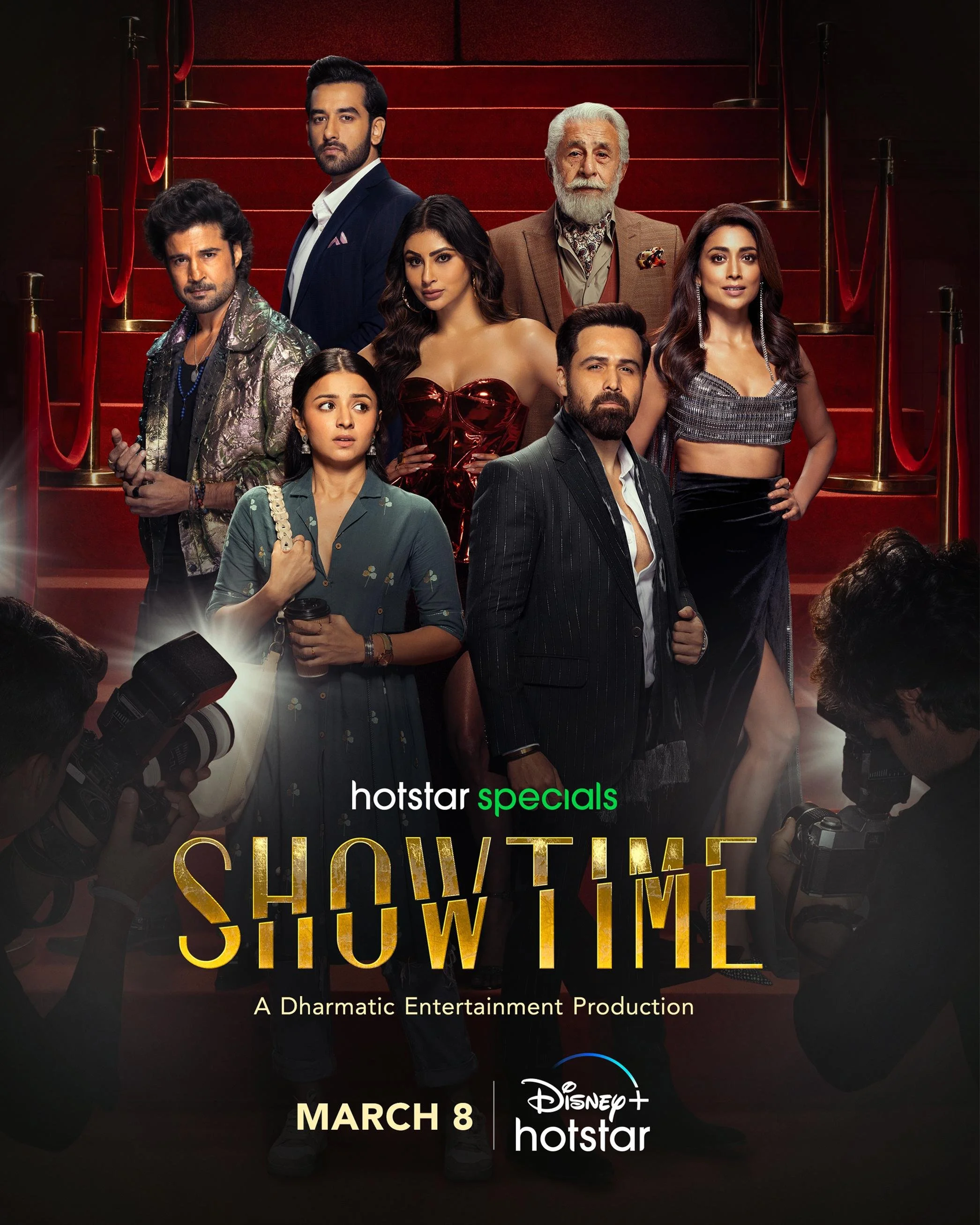 Poster for the show 'Showtime' featuring nine people dressed in glamorous clothes, standing on a red carpeted staircase, with photographers taking pictures. The poster includes the Hotstar specials logo, Disney+ Hotstar logo, and states the release date March 8.