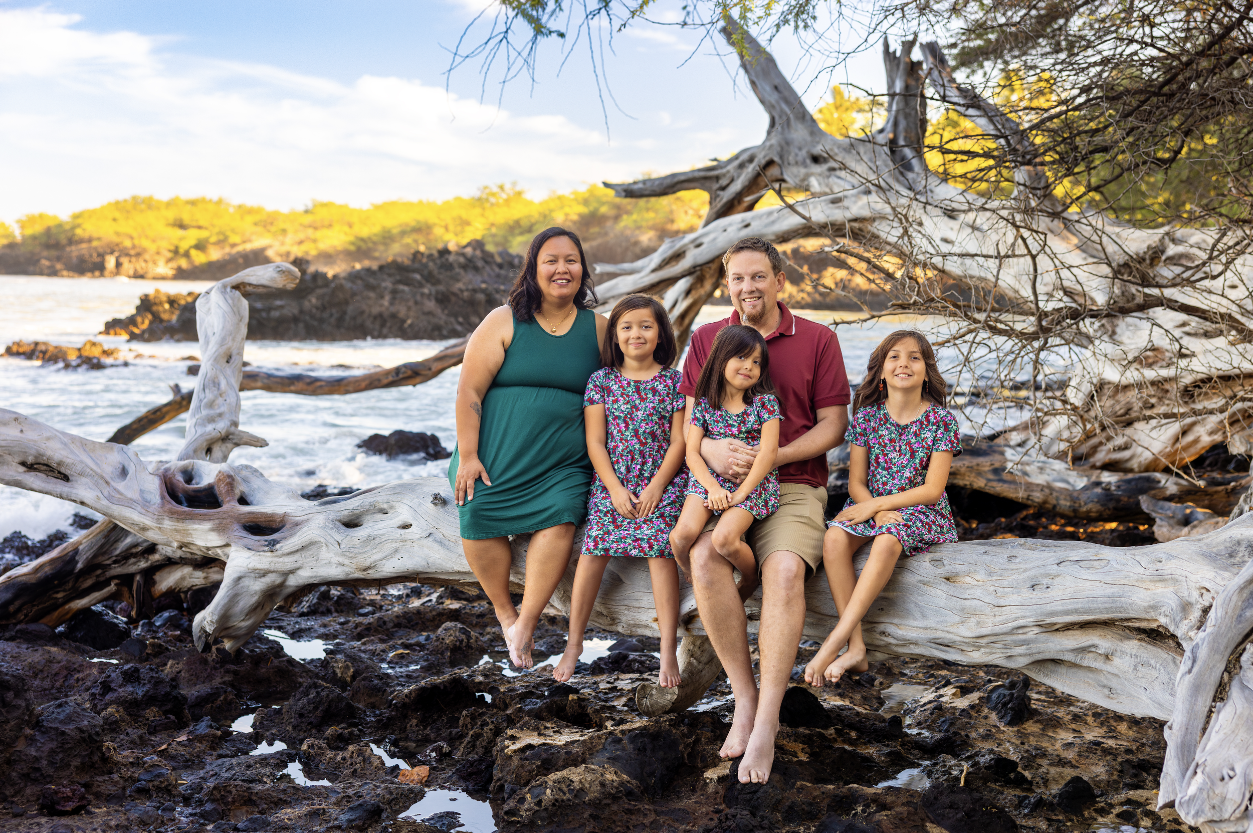 Family portrait of five people, smiling for their photographer Cynthia Buckles with CynthiArtistry. Cynthia Buckles is rated best photographer on the Big Island of Hawaii near Waimea, Waikoloa and Kona. Cynthia specializes in Candid Natural Portraits