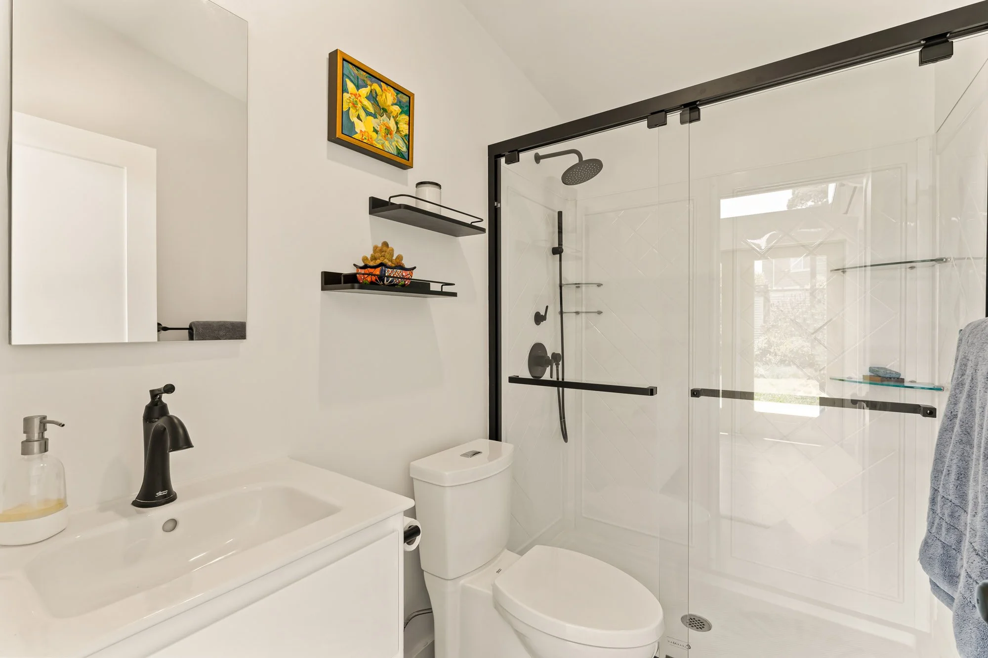 Contemporary ADU bathroom with a frameless glass shower, efficient layout, and low-maintenance finishes in Santa Cruz County.