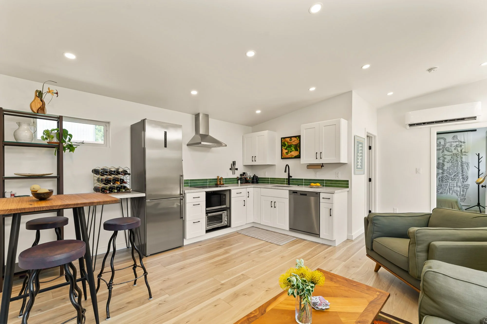 Open-concept kitchen with custom cabinetry, full-size appliances, and modern finishes inside a Santa Cruz accessory dwelling unit.