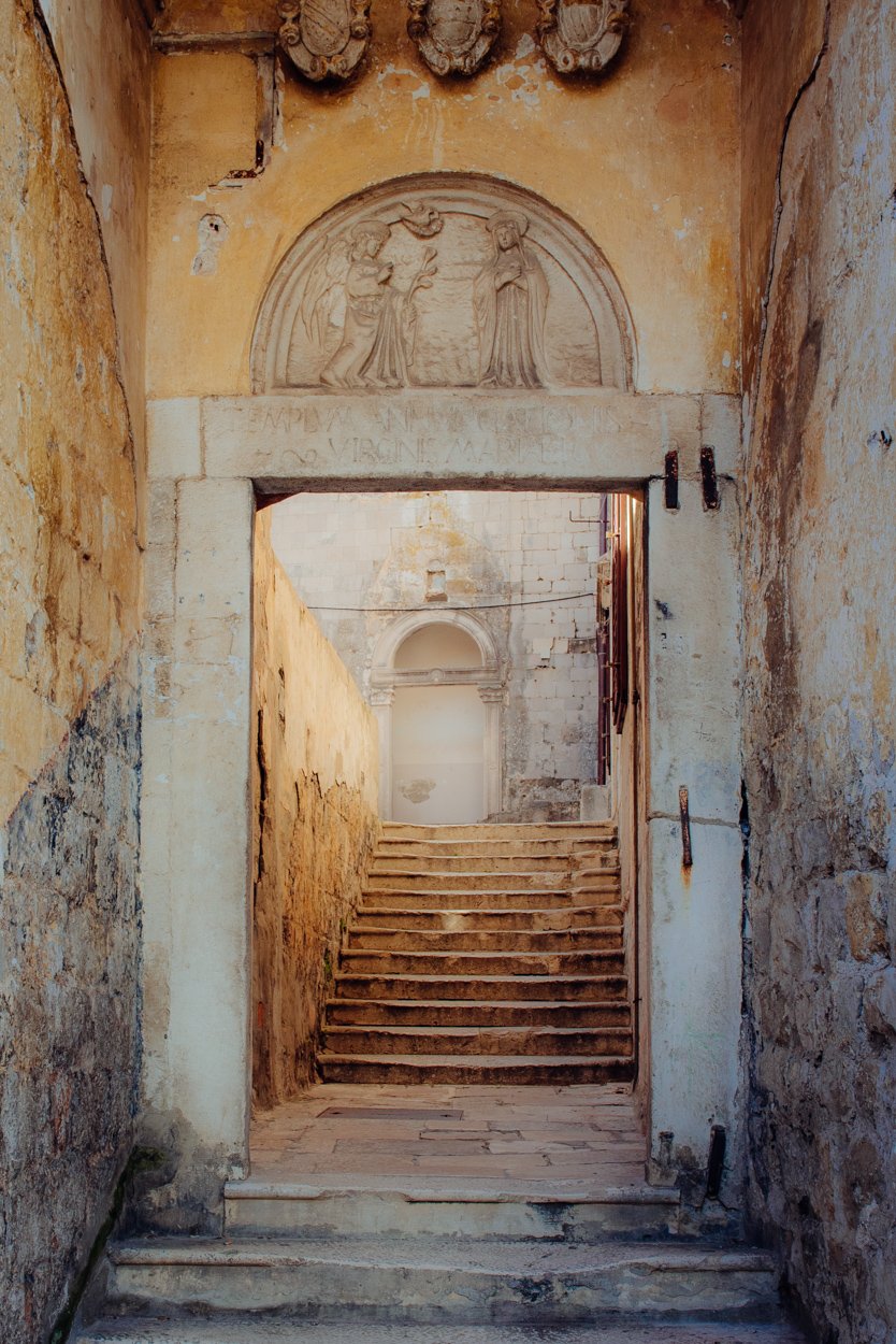 A Baroque doorway to stairs and a courtyard.